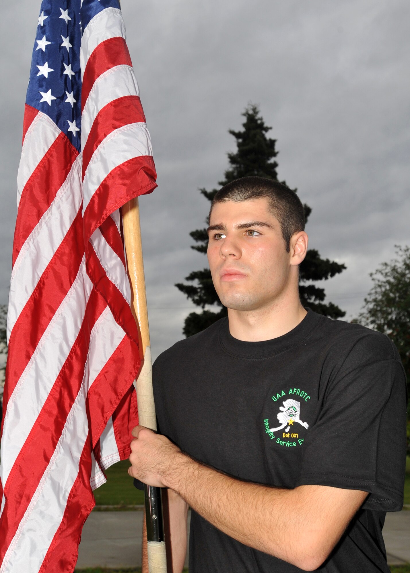 ELMENDORF AIR FORCE BASE, Alaska -- University of Alaska Anchorage Air Force ROTC cadet Nicholas George holds the American flag steady while waiting to begin a memorial run Sept. 11, 2009. The ROTC cadets ran around Elmendorf for 24 hours beginning at 8:46 a.m., the time the first of the World Trade Center twin towers was hit in 2001. The cadets were relieved by other runners every half hour during the 24-hour period. (U.S. Air Force photo/Senior Airman Laura Turner)