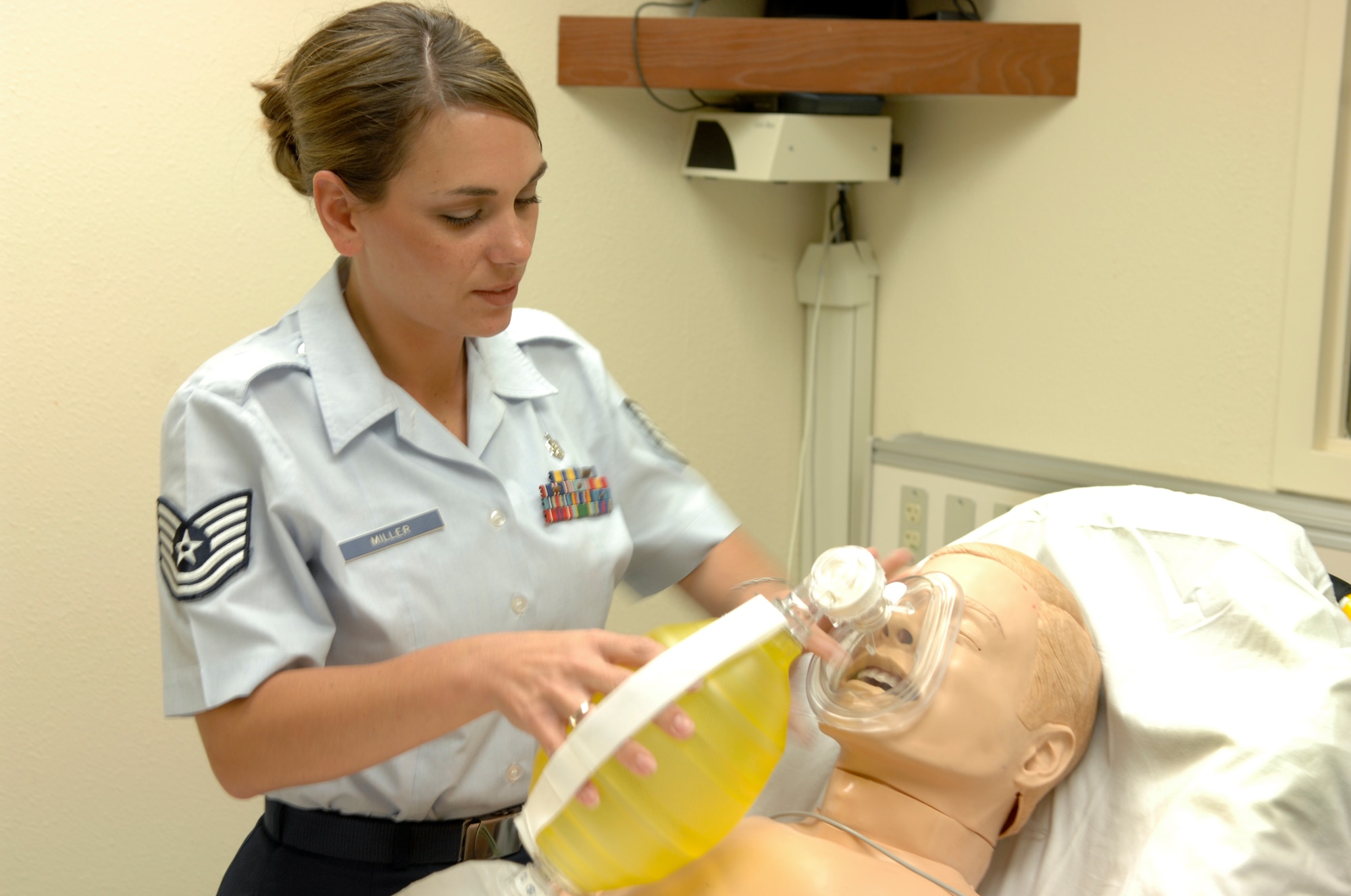 Tech. Sgt. Amy Miller demonstrates how to perform cardiopulmonary resuscitation on a CPR dummy at Elmendorf Air Force Base, Alaska. Sergeant Miller is an emergency medical technician coordinator and 3rd Wing self aid and buddy care advisor. (U.S. Air Force photo/Airman Jack Sanders)