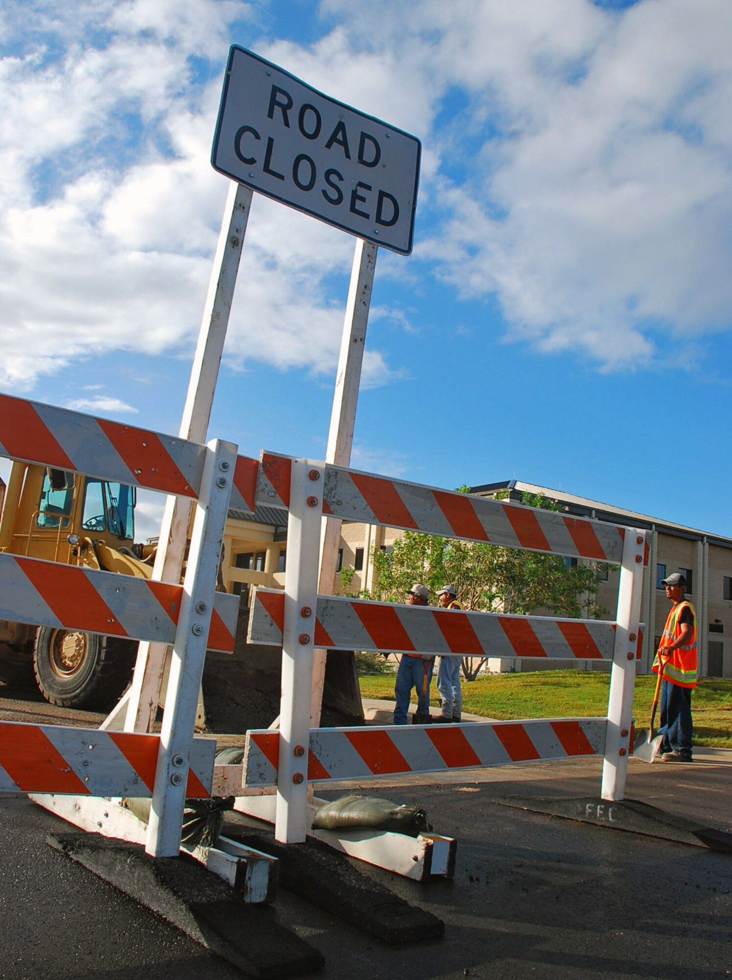 LAUGHLIN AIR FORCE BASE, Texas – A contracted construction team works on a portion of road in front of the 47th Flying Training Wing headquarters building here Sept. 11. This project is one of the many construction projects in progress that aim to help improve the base and quality of life for Airman, due to the efforts of the 47th Contracting Squadron, the 47th Installation Support Squadron and  stimulus funds given to Laughlin recently. (U.S. Air Force photo by Senior Airman Sara Csurilla) 