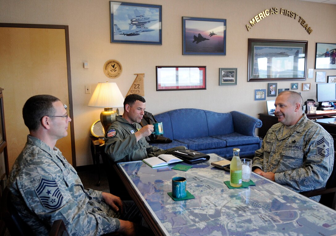 LANGLEY AIR FORCE BASE, Va. -Col. Matthew Molloy, 1st Fighter Wing commander, Chief Master Sgt. Kevin Slater (left), 1st Fighter Wing Command chief and Chief Master Sgt. Scott Dearduff, command chief for the 9th Air Force and U.S. Air Forces Central Command, sit down in preparation for an office call here Sept.11. Chief Dearduff visited with Airmen and toured some of Langley's squadrons after attending the Air Combat Command change-of-command Sept. 10. (U.S. Air Force photo/Senior Airman Dana Hill)
