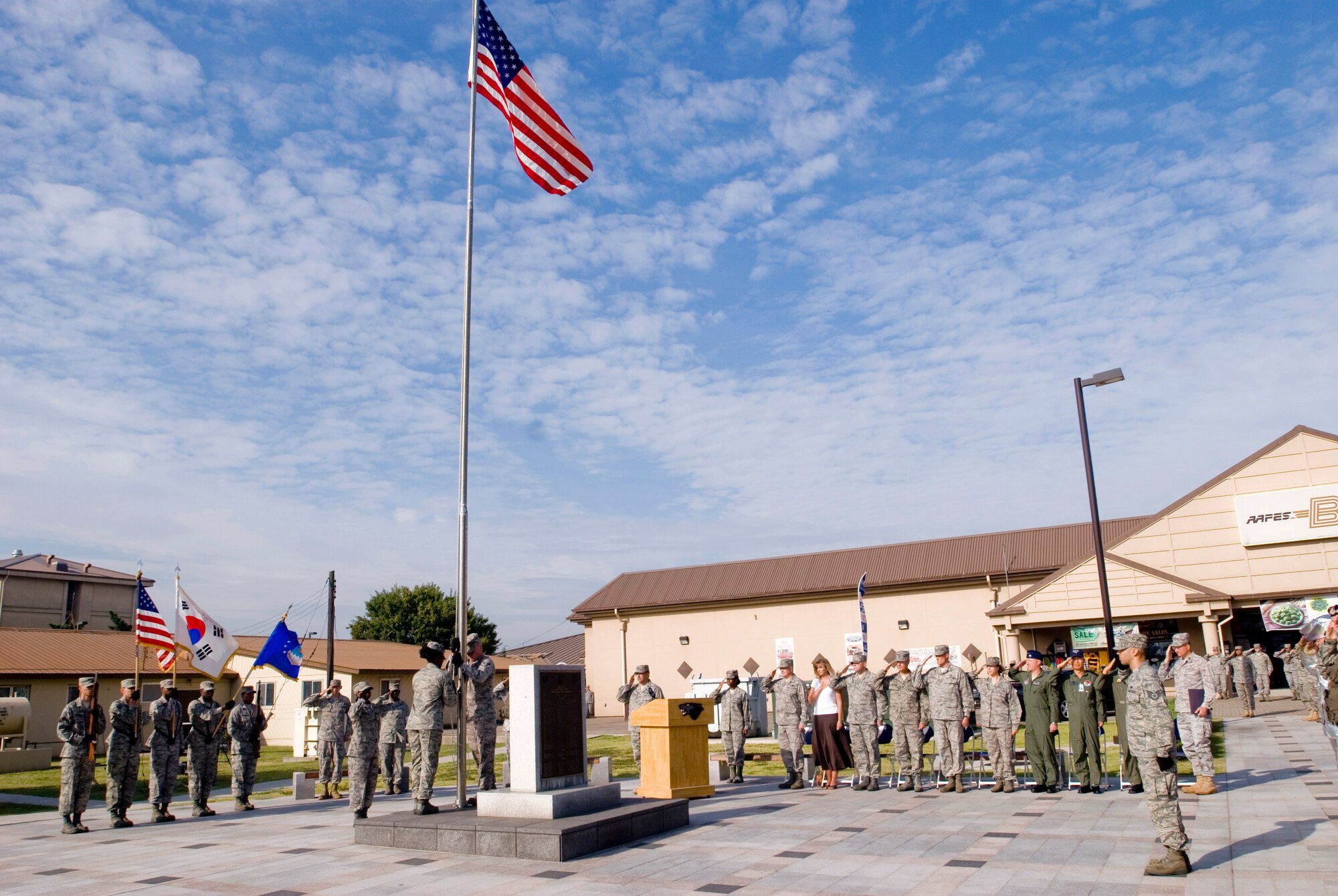 Servicemembers and guests salute the U.S. flag during the September 11 Patriot Day Ceremony Sept. 11, 2009, at Kunsan Air Base, Republic of Korea. The ceremony acknowledged the courageous firefighters, police officers, emergency responders and others who risked their lives to save the victims of the tragic events of Sept. 11, 2001. The ceremony also paid tribute to the men and women of the U.S. Armed Forces who have served in the military, whether deployed or at home station, since these events. (U.S. Air Force photo/Senior Airman Jonathan Steffen)