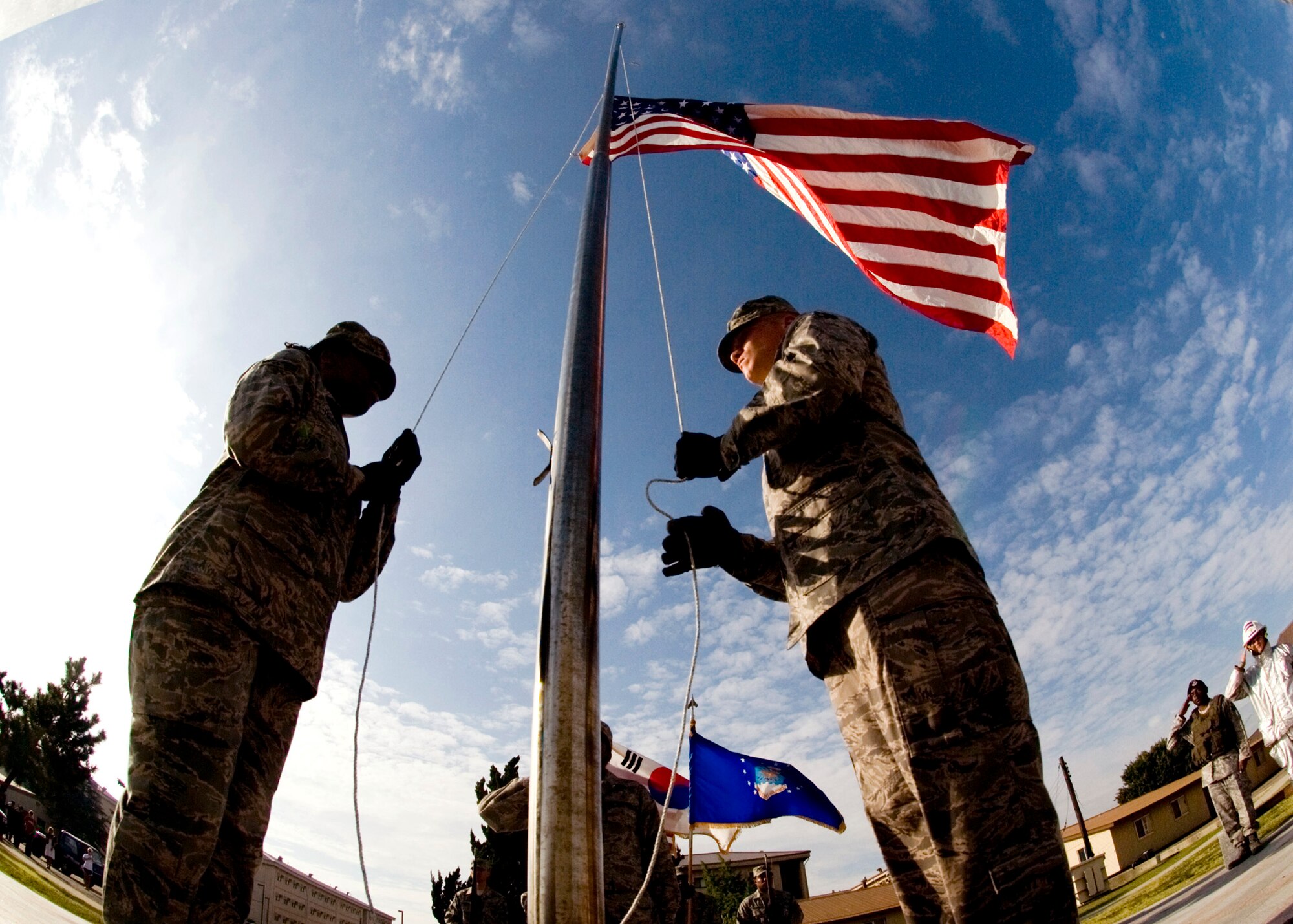 Senior Airman Danielle Todman (left) and Airman 1st Class Kyle Detwiler post the colors during the September 11 Patriot Day Ceremony Sept. 11, 2009, at Kunsan Air Base, Republic of Korea.  The ceremony acknowledged the courageous firefighters, police officers, emergency responders and others who risked their lives to save the victims of the tragic events of Sept. 11, 2001. The ceremony also paid tribute to the men and women of the U.S. Armed Forces who have served in the military, whether deployed or at home station, since these events. (U.S. Air Force photo/Senior Airman Jonathan Steffen)