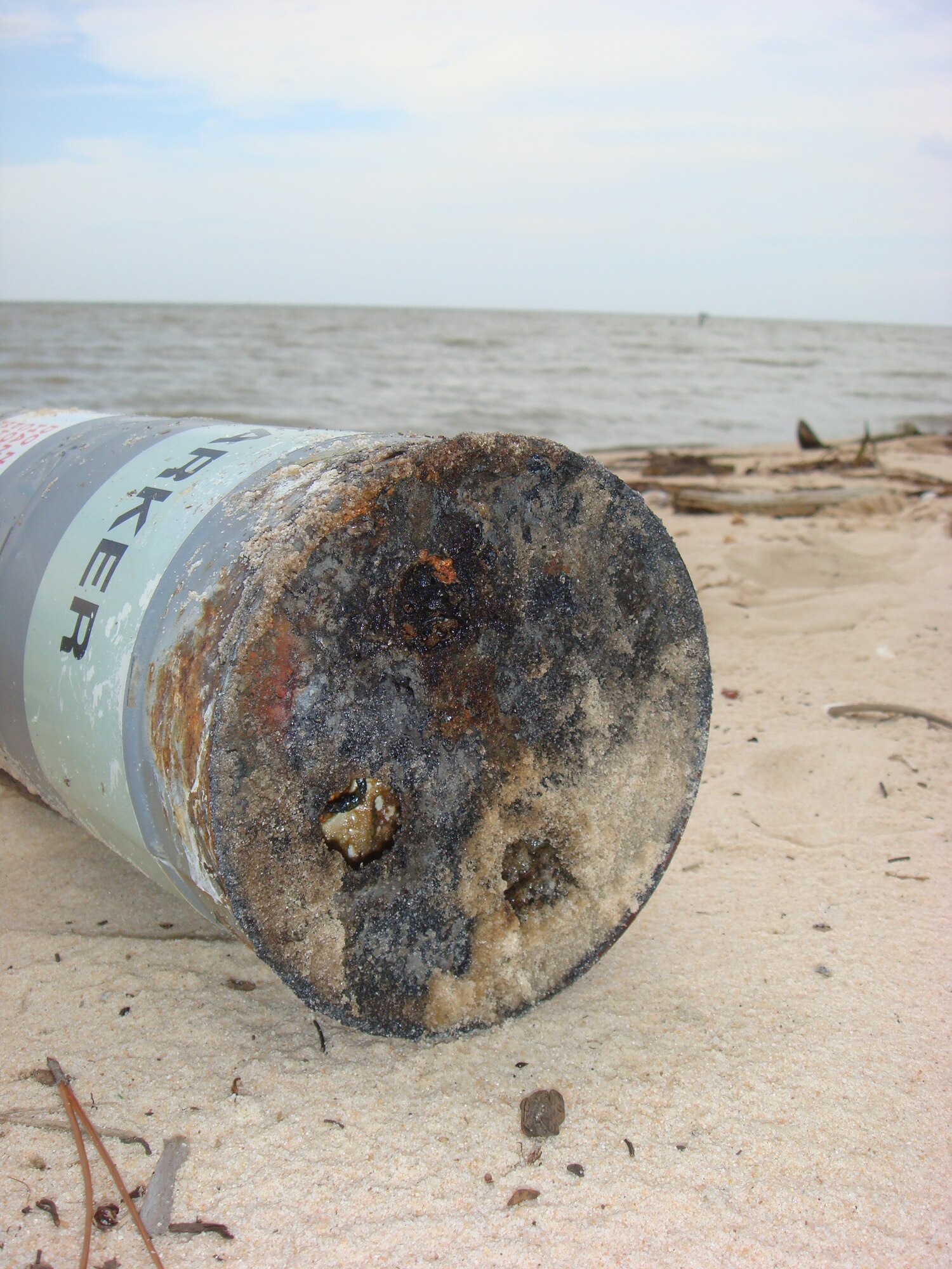 This crater is all that was left after explosive ordnance disposal technicians from Hurlburt Field destroyed a 21-inch-long canister during an off-base response in Dauphin Island, Ala. The item is a marine marker, which is basically the water version of a road flare.  (Courtesy photo)                            