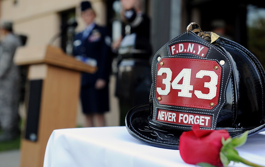 MOODY AIR FORCE BASE, Ga. -- A New York fire department helmet sits on a table with the words “never forget” written on it, symbolizes the heroic efforts made by those firefighters who rushed into the World Trade Center buildings during a 9/11 ceremony here Sept. 11. (U.S. Air Force photo by Airman 1st Class Joshua Green) 