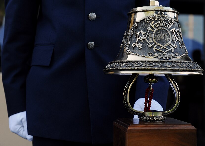 MOODY AIR FORCE BASE, Ga. -- An Airman from the 23rd Civil Engineer Squadron, rings a fire bell symbolizing the last call for fallen firefighters during a 9/11 ceremony here Sept. 11. Members of the Moody Fire Department and local community firefighters came together to remember their fellow firefighters who were lost during that tragic day.  (U.S. Air Force photo by Airman 1st Class Joshua Green) 