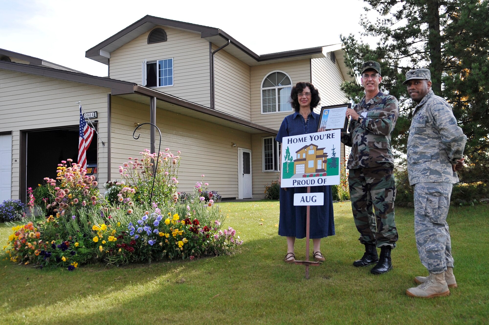 Maj. Charles Houlding and his wife, Linda, display their Home You're Proud Of award with Col. Karlton Johnson Sept. 10, 2009, Eielson Air Force Base, Alaska. Each winner received gift cards from agencies on and off base. Major Houlding is assigned to the 354th Medical Operations Squadron and Colonel Johnson is the 354th Mission Support Group commander. (U.S. Air Force photo/Staff Sgt. Christopher Boitz) 