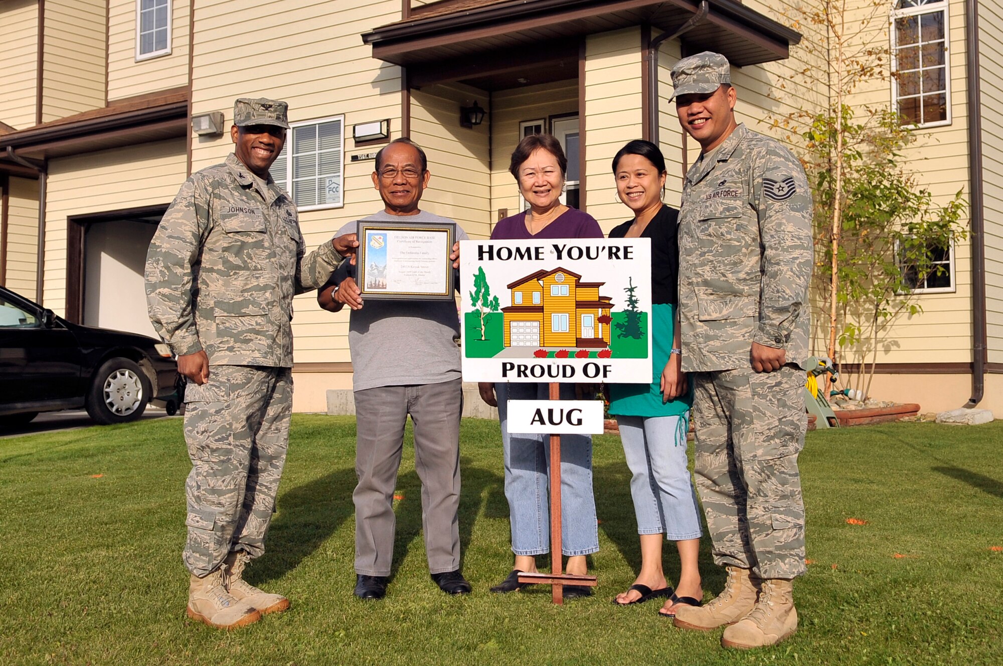 Tech. Sgt. Mauro Ordinario and his family display their Home You're Proud Of award with Col. Karlton Johnson Sept. 10, 2009, Eielson Air Force Base, Alaska. Each winner received gift cards from agencies on and off base. Sergeant Ordinario is assigned to the 354th Maintenance Squadron and Colonel Johnson is the 354th Mission Support Group commander. (U.S. Air Force photo/Staff Sgt. Christopher Boitz) 