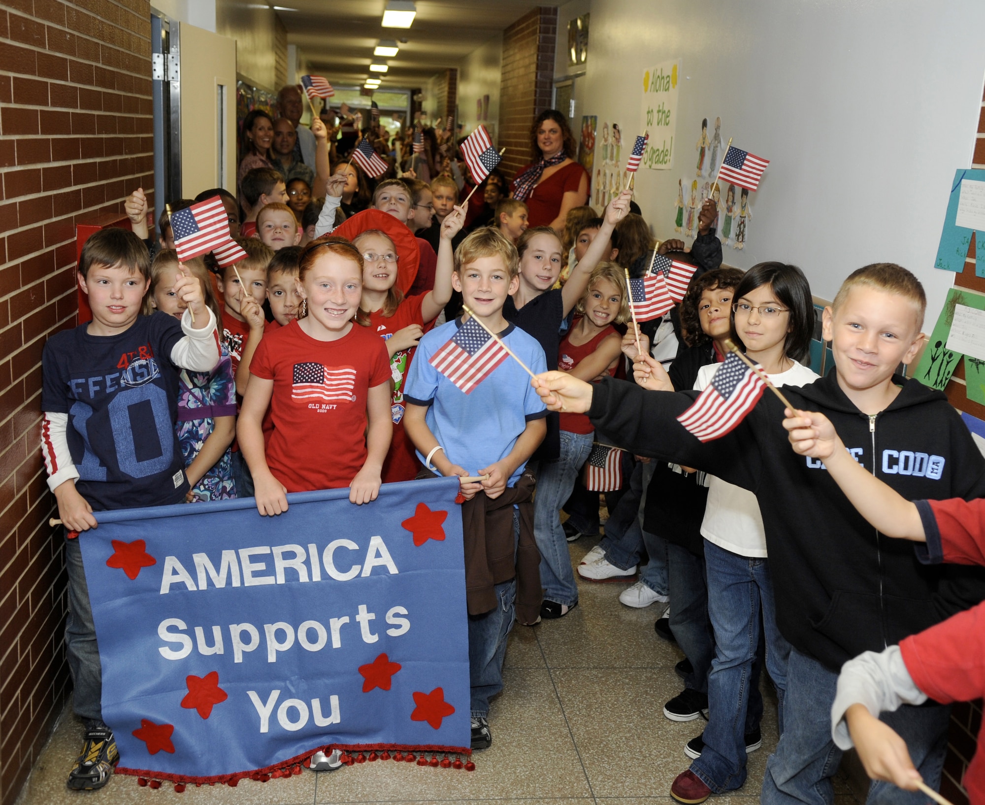 Students, parents and teachers participate in a Freedom Walk in the Columbia School at Joint Base McGuire-Dix-Lakehurst Sept. 11. The event is held every year to honor and support the U.S. military, firefighters, police officers, and emergency medical services. Before the Freedom Walk began, a moment of silence was held to remember the victims and heroes of the Sept. 11, 2001 terrorist attacks. (U.S. Air Force photo/Carlos Cintron)
