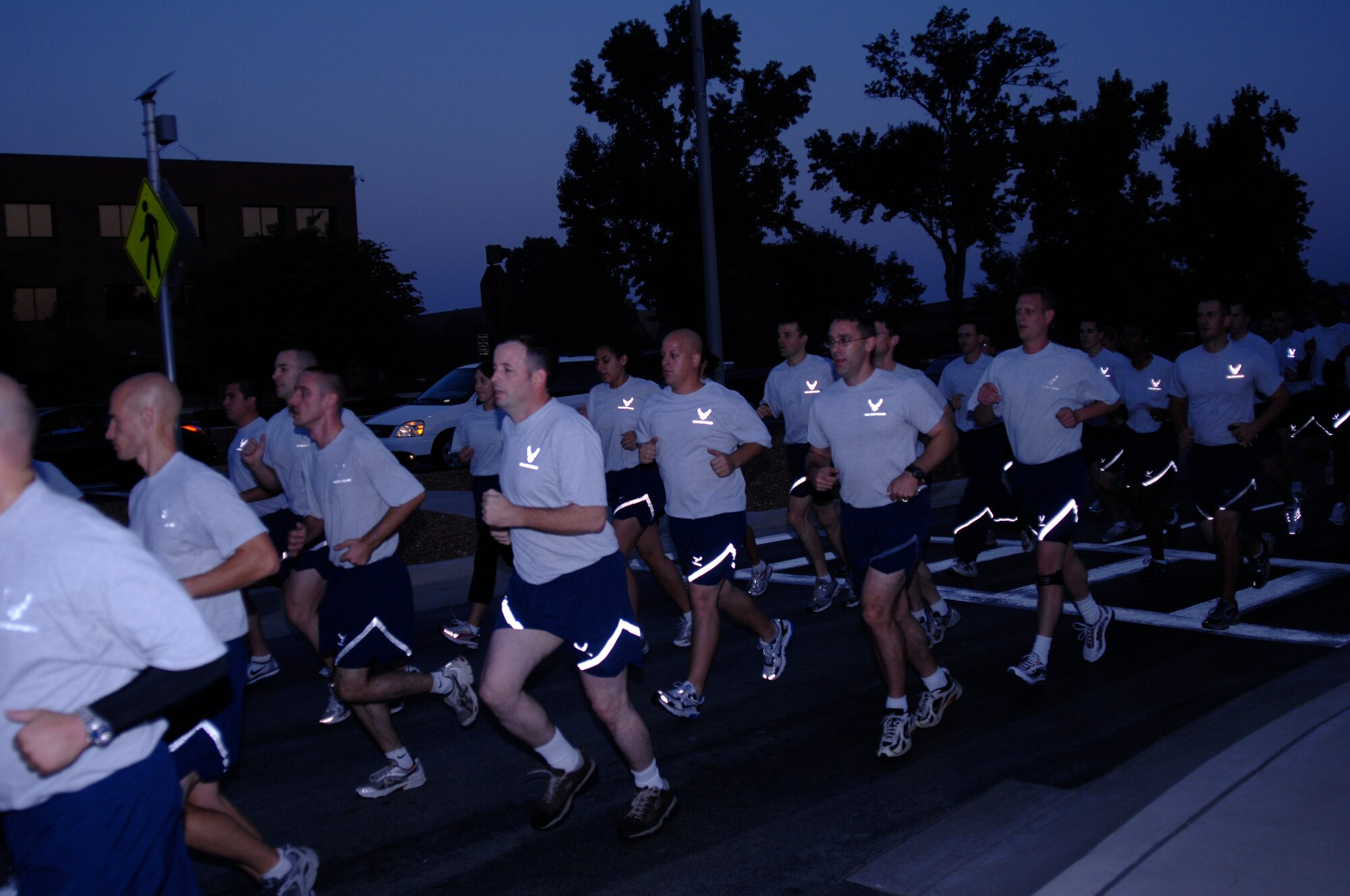 SCOTT AIR FORCE BASE, Ill. -- Team Scott runs down Scott Drive performing Air Force chants during the 9/11 remembrance run. The base ran a total of 2 miles around the base to show their support for the victims of the 9/11 attacks. (U.S. Air Force photo/Airman 1st Class Amber Kelly-Herard) 