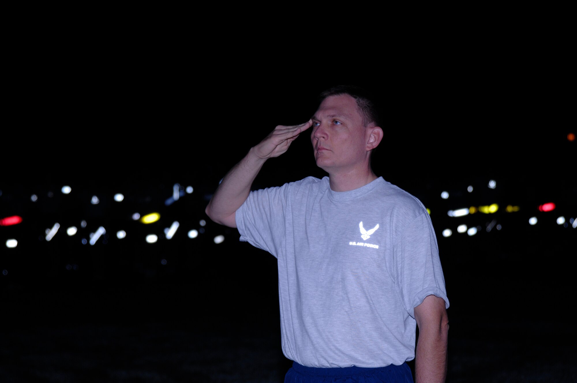 SCOTT AIR FORCE BASE, Ill. -- Col. John Odey, Air Force Network Integration Center commander, salutes the flag as it is raised to half-staff during the 9/11 remembrance ceremony. AFNIC hosted the base-wide run and ceremony. (U.S. Air Force photo/Airman 1st Class Amber Kelly-Herard) 