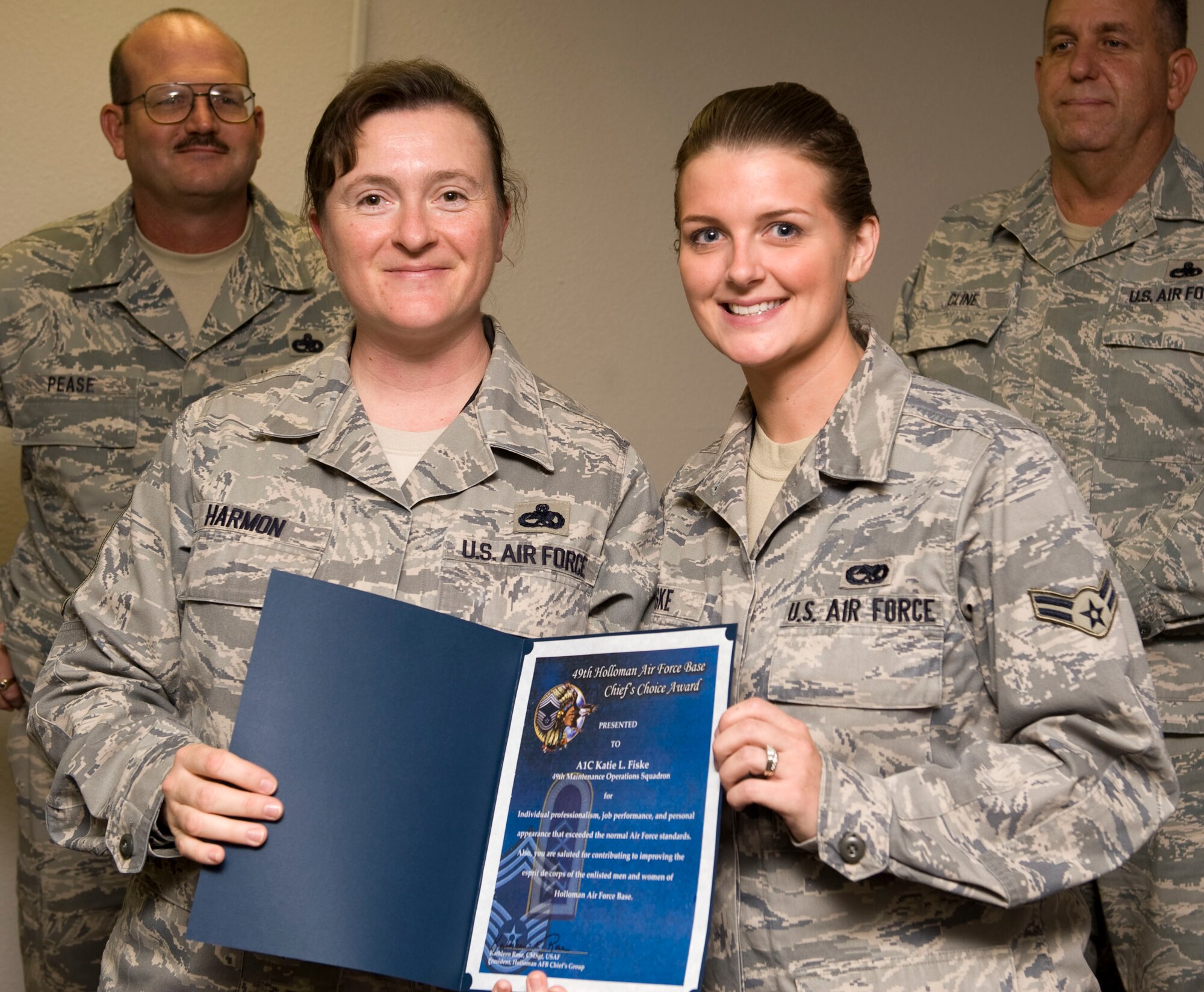 HOLLOMAN AIR FORCE BASE, N.M. -- Chief Master Sgt. Kathy Harmon, 49th Maintenance Squadron, presents Airman 1st Class Katie Fiske, 49th Maintenance Operations Squadron, with the  Chief's Choice award for August 2009. Airman Fiske is a Maintenance Data Systems Analyst currently assigned as a dedicated analyst for the F-22A Low Observables Section in the 49th MXS. (U.S. Air Force photo by Senior Airman Rachel Kocin)