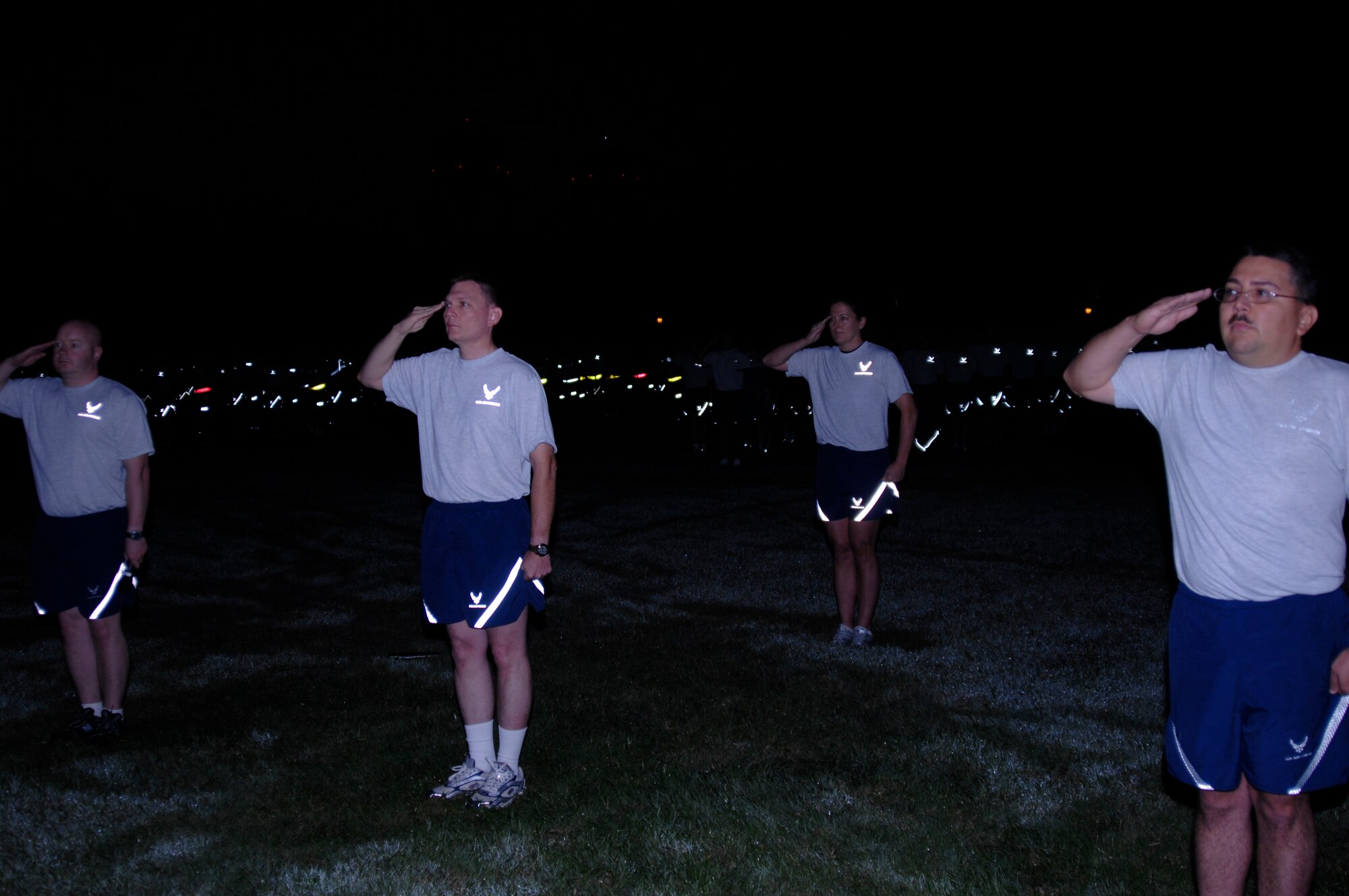 SCOTT AIR FORCE BASE, Ill. -- Air Force Network Integration Center leadership salutes, with Team Scott saluting in the backgroud, as the colors are posted. AFNIC hosted the 9/11 remembrance run. (U.S. Air Force photo/Airman 1st Class Amber Kelly-Herard) 