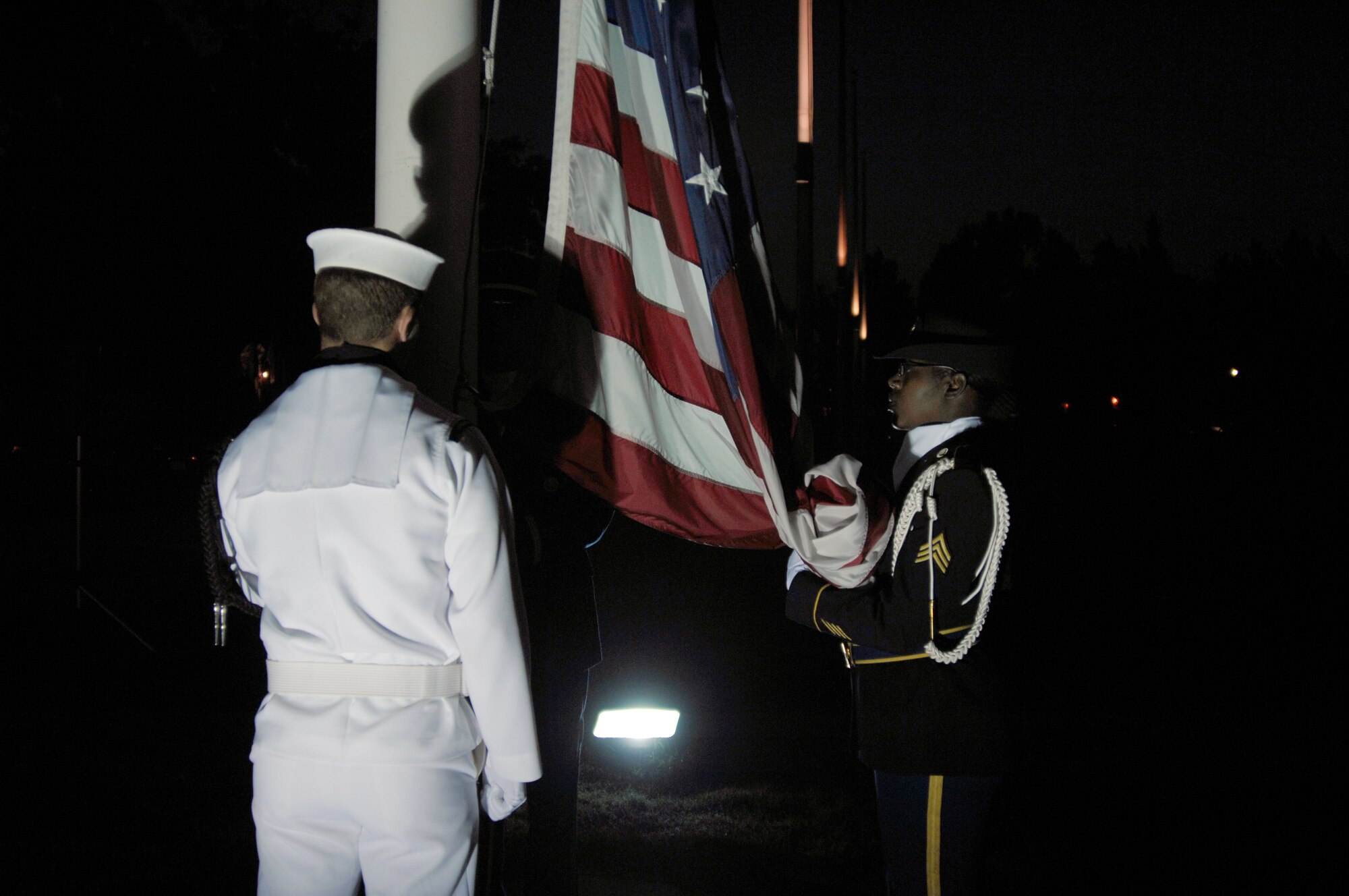 SCOTT AIR FORCE BASE, Ill. -- Members of the Joint Color Guard from U.S. Transportation Command prepare to post the colors during the 9/11 rememberance run ceremony at the Parade Field. All of Team Scott was present to pay respect to victims of the attacks, as well as those who are still fighting for freedom. 
(U.S. Air Force photo/Airman 1st Class Amber Kelly-Herard) 
