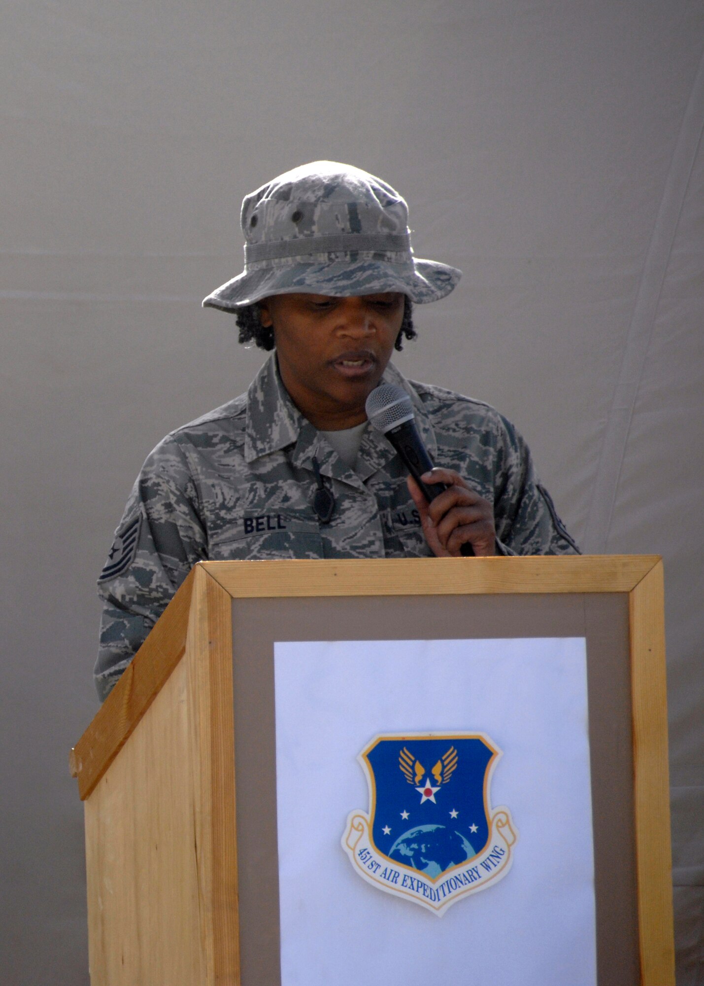 Technical Sgt. Pamela Bell reads the poem "Remember September" by Andrew St. Wilson during a Sept. 11, 2001, memorial ceremony here Sept. 11, 2009, as more than 100 Airmen from the 451st Air Expeditionary Wing on Kandahar Airfield, Afghanistan, observed the anniversary. (U.S. Air Force photo/Senior Airman Timothy Taylor)
