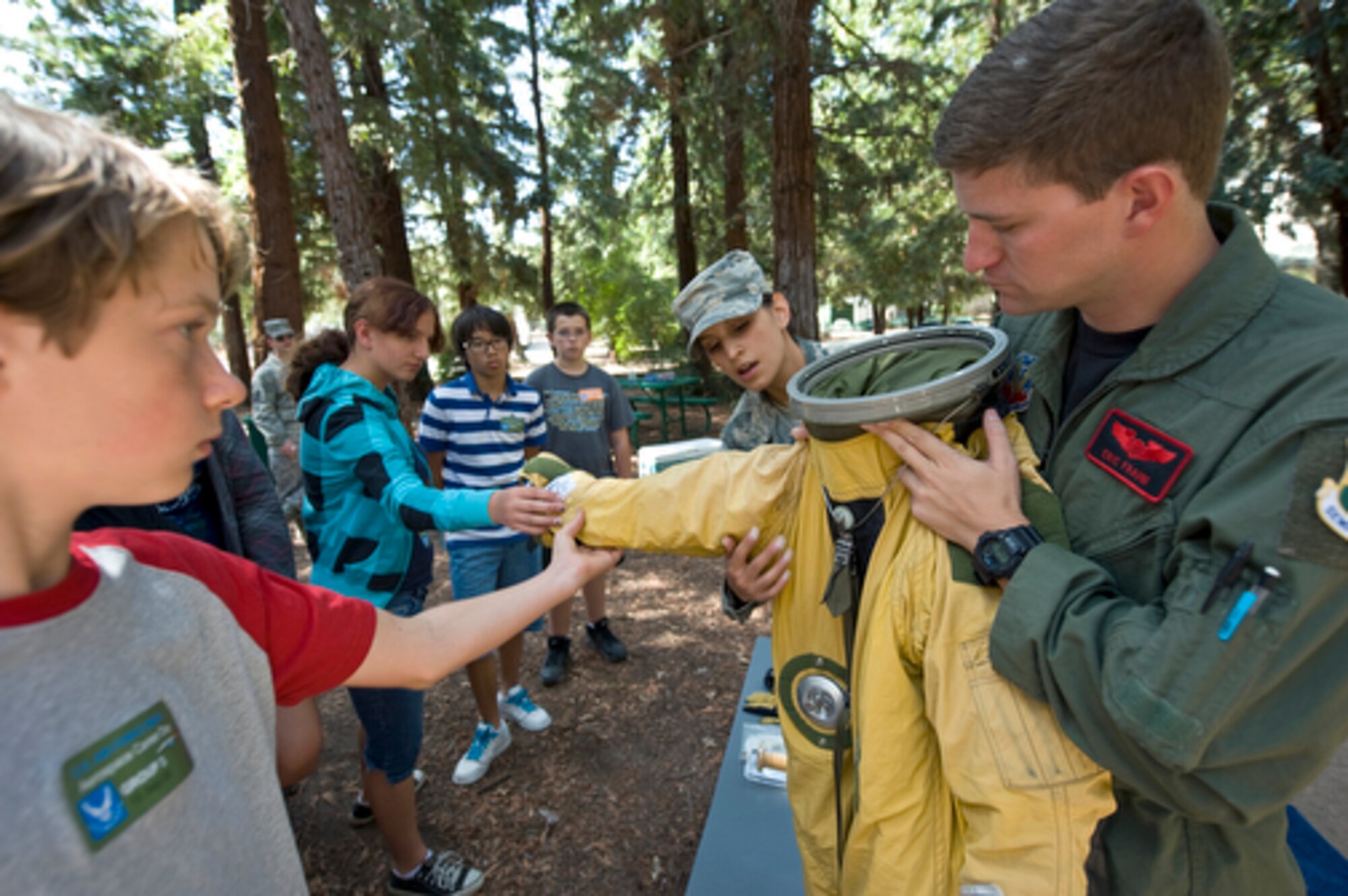 Capt. Eric Frahm and Senior Airman Natalie Valle give 8th graders from Arcade Middle School a hands-on opportunity with a U-2 pilot’s suit and helmet during aerospace career day at Discovery Museum of Sacramento for Air Force Week, Sept. 10, 2009. Air Force Week-Sacramento is an event using various activities and exhibitions to educate the community about the Air Force's capabilities and missions. Captain Frahm is a U-2 pilot and Airman Valle is a suit technician for the high-altitude reconnaissance aircraft, both are stationed at Beale Air Force Base, Calif. (U.S. Air Force photo/Staff Sgt. Bennie J. Davis III)