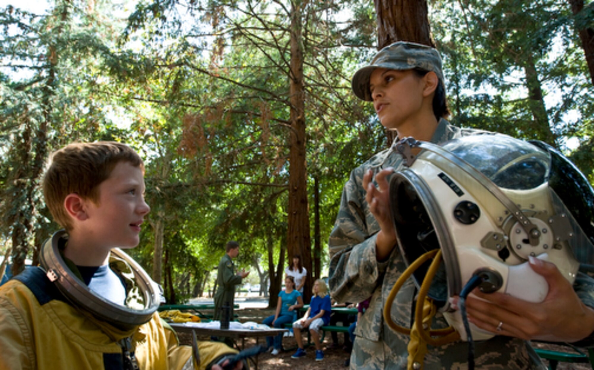 Senior Airman Natalie Valle gives Noah Davis, 9, a hands-on opportunity with the aircraft's suit and helmet during aerospace career day at Discovery Museum of Sacramento for Air Force Week, Sept. 10, 2009. Air Force Week-Sacramento is an event using various activities and exhibitions to educate the community about the Air Force's capabilities and missions. Senior Airman Valle is a suit technician for the U-2 high-altitude reconnaissance aircraft and a member of the 9th Physiological Support Squadron at Beale Air Force Base, Calif. (U.S. Air Force photo/Staff Sgt. Bennie J. Davis III)