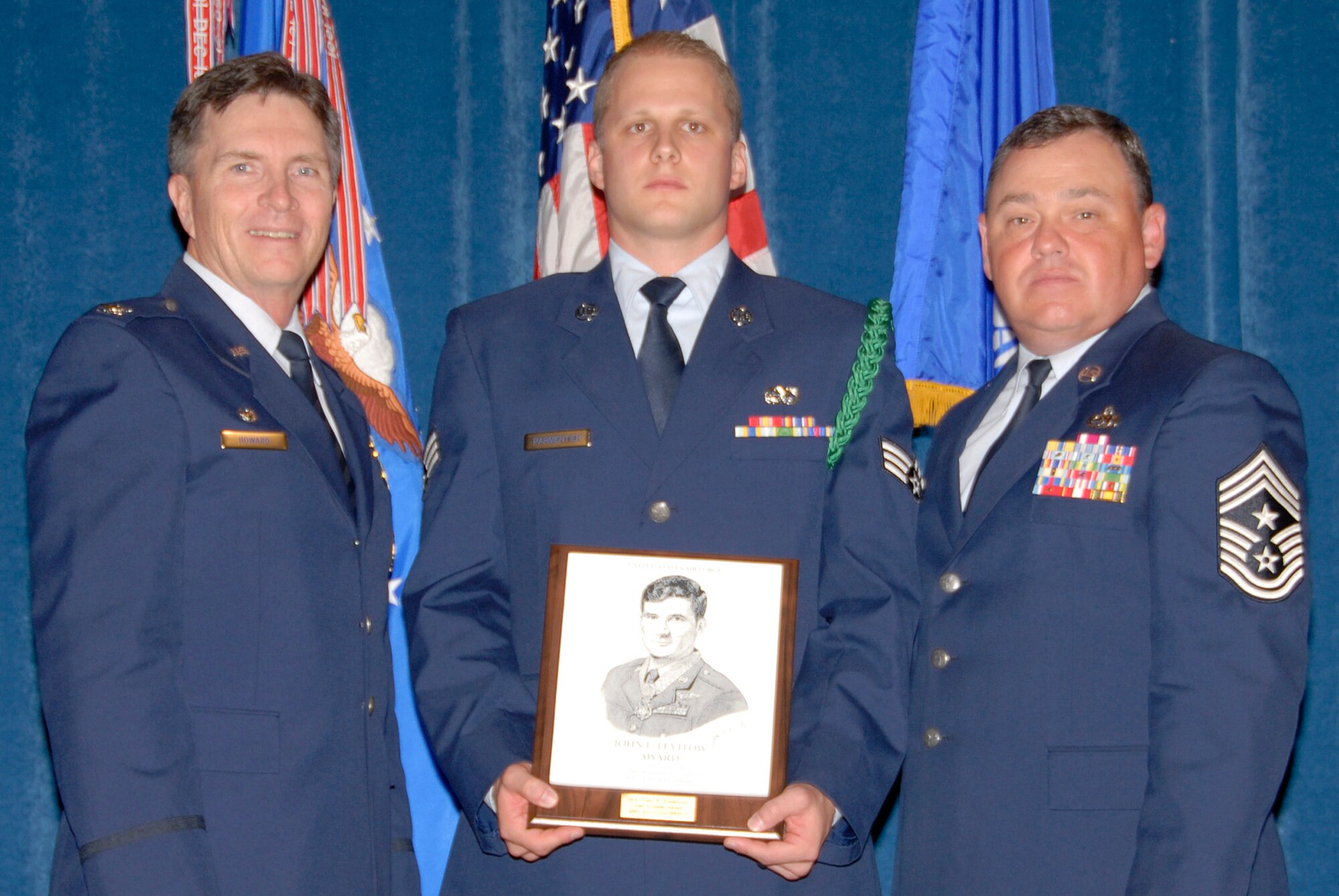 McGHEE TYSON AIR NATIONAL GUARD BASE, Tenn. -- Senior Airman James K. Parmentier, a guidance and control systems avionics technician with the 129th Rescue Squadron, California Air National Guard, receives the John L. Levitow Honor Award for Airman Leadership School Class 09-5 at The Air National Guard Training and Education Center here from Col. Richard B. Howard and Chief Master Sgt. James B. Long, Sept. 10, 2009.  The John L. Levitow Award is the highest honor awarded a graduate of any Air Force enlisted professional military education course.  (U.S. Air Force photo by Master Sgt. Kurt Skoglund)(Released)