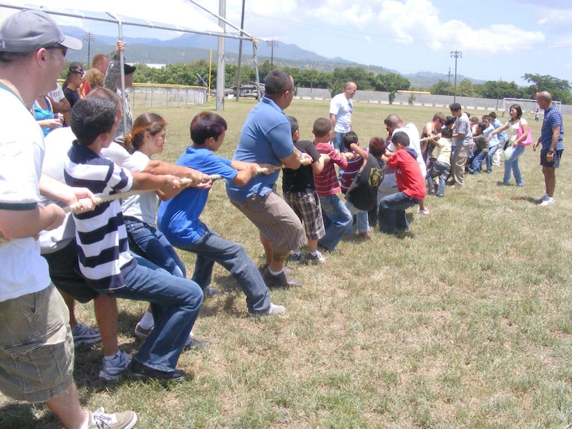 SOTO CANO AIR BASE, Honduras — Local children and volunteers play tug-of-war during the Joint Task Force-Bravo’s “kid’s day” Sept. 10 near the base soccer field. More than 100 children from local orphanages were transported to base for the event. The children participated in a variety of events the volunteers organized including a HH-60 Blackhawk static display, military working dog demonstration and fire truck display. The children also got to participate in soccer, kickball and a water balloon toss. A free lunch was also served and the children were given a “goodie” bag containing small toys and candy as the left base (U.S. Air Force photo/Martin Chahin).