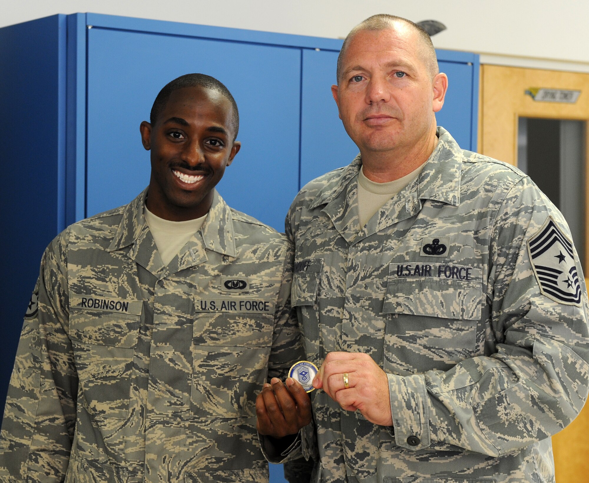 LANGLEY AIR FORCE BASE, Va. -- Chief Master Sgt. Scott Dearduff, command chief for the 9th Air Force and U.S. Air Forces Central Command recognizes Staff Sgt. Nathaniel Robinson Jr, 1st Operations Support Squadron aircrew flight equipment craftsman, during his visit here Sept. 11.  Chief Dearduff visited with Airmen and toured some of Langley's squadrons after attending the Air Combat Command change-of-command Sept. 10. (U. S. Air Force photo/Senior Airman Wolf)