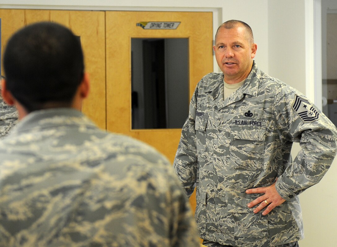 LANGLEY AIR FORCE BASE, Va. -- Chief Master Sgt. Scott Dearduff, command chief for the 9th Air Force and U.S. Air Forces Central Command answers a question from Senior Airman Hector Rivera Vazquez, 1st Operations Support Squadron aircrew flight equipment journeyman, during his visit here Sept. 11.  Chief Dearduff visited with Airmen and toured some of Langley's squadrons after attending the Air Combat Command change-of-command Sept. 10. (U.S. Air Force photo/Senior Airman Wolf)