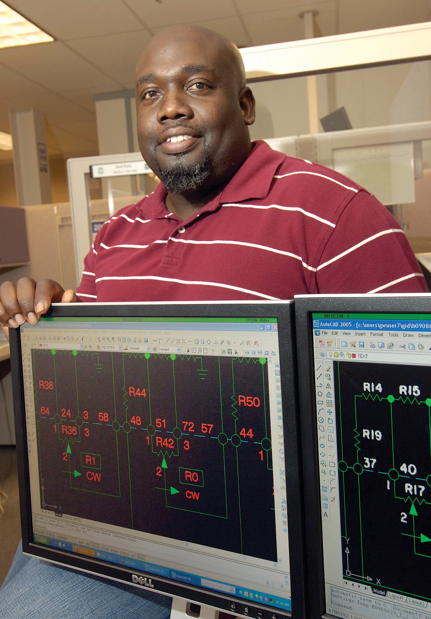As a technical order illustrator in the 420th Supply Chain Management Squadron, Jerron Johnston gives new life to old, unreadable TOs. Often having to recreate the detailed orders that mechanics rely on, Mr. Johnston creates a new easy-to-read digital version out of the old TOs that are faded, full of creases or over-scanned. (Air Force photo by Margo Wright) 