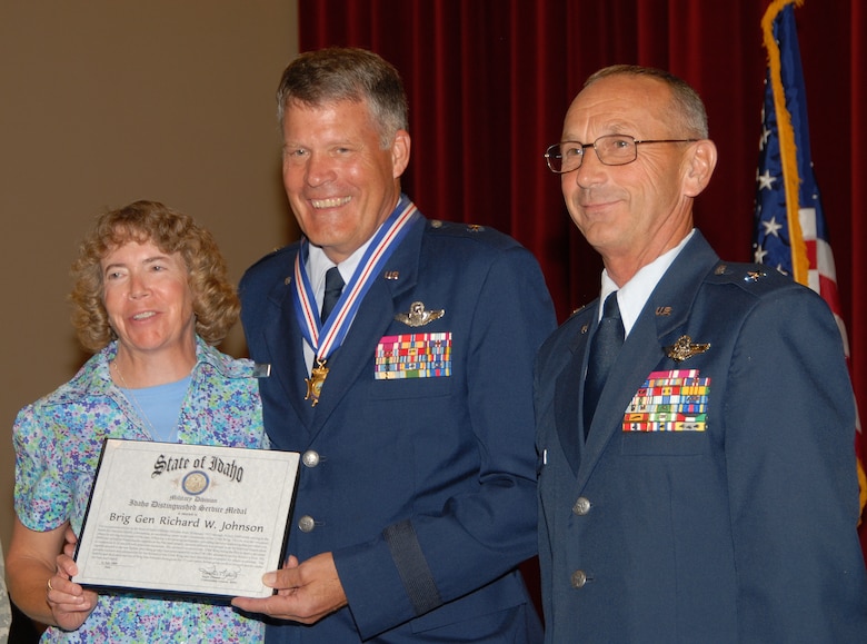 Retired Brig. Gen. Richard Johnson accepts the Idaho Distinguished Service Medal with wife, Mary, and Deputy Commanding General, Air, Brig. Gen. Gary Sayler July 11 (Air Force Photo by Master Sgt. Tom Gloeckle)(Released)