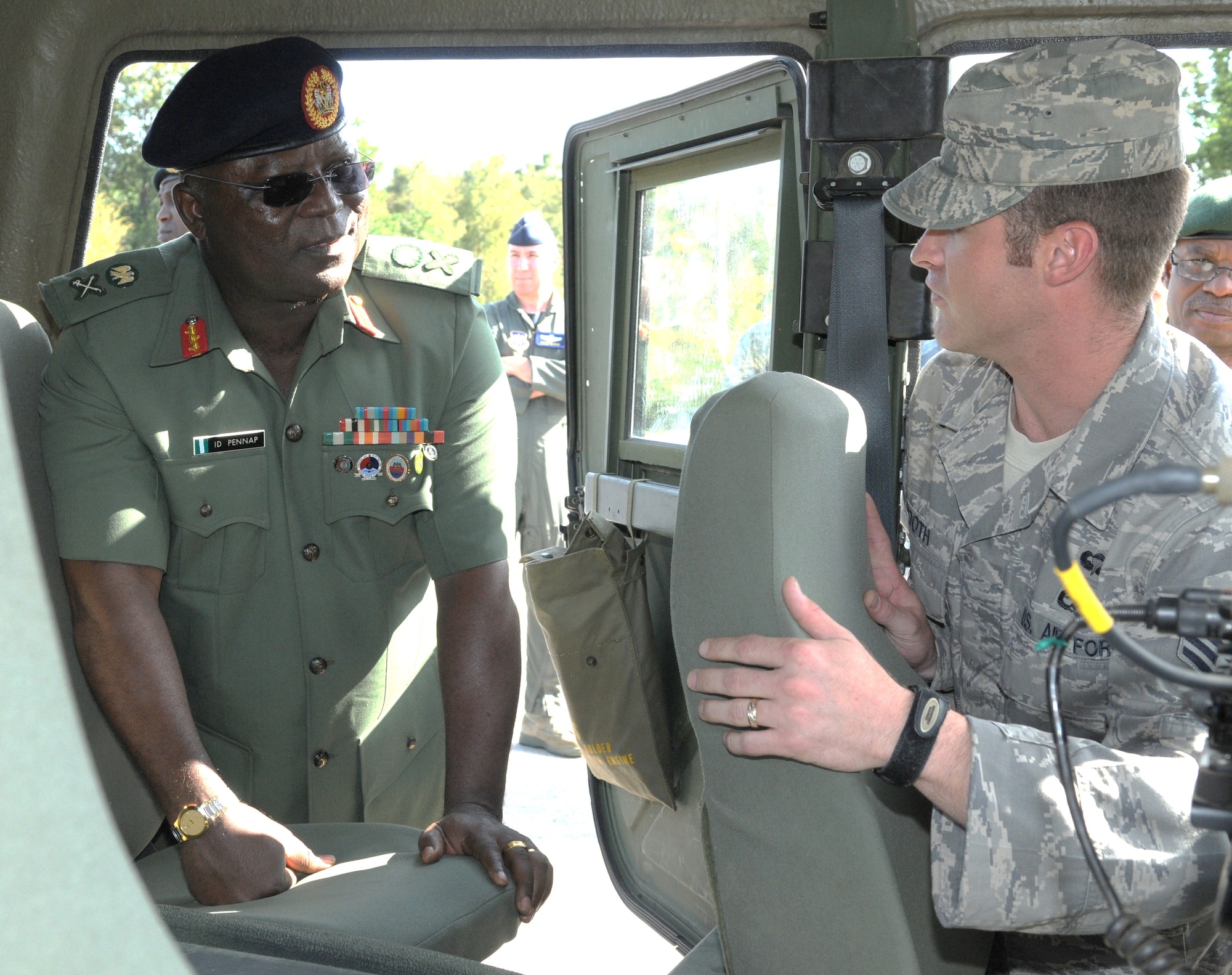 RAMSTEIN AIR BASE, Germany -- Nigerian Armed Forces Maj. Gen. Pennap receives an orientation on a rapidly deployable Hummer from ground radio operator Staff Sgt. Ronald Booth of the 435th Contingency Response Group Sept. 11 here. The General was part of a group of Nigerian military officials who visited Ramstein as part of a visit to U.S. Africa Command. They received a series of orientations to provide information and the basis for continued cooperation between U.S. and Nigerian forces. 
The group was hosted at Ramstein by 17th Air Force (Air Forces Africa). As the air component for U.S. Africa Command, 17 AF has been partnering with Nigeria, and conducted three engagements with the nation in August. (USAF photo by Master Sgt. Jim Fisher) 
