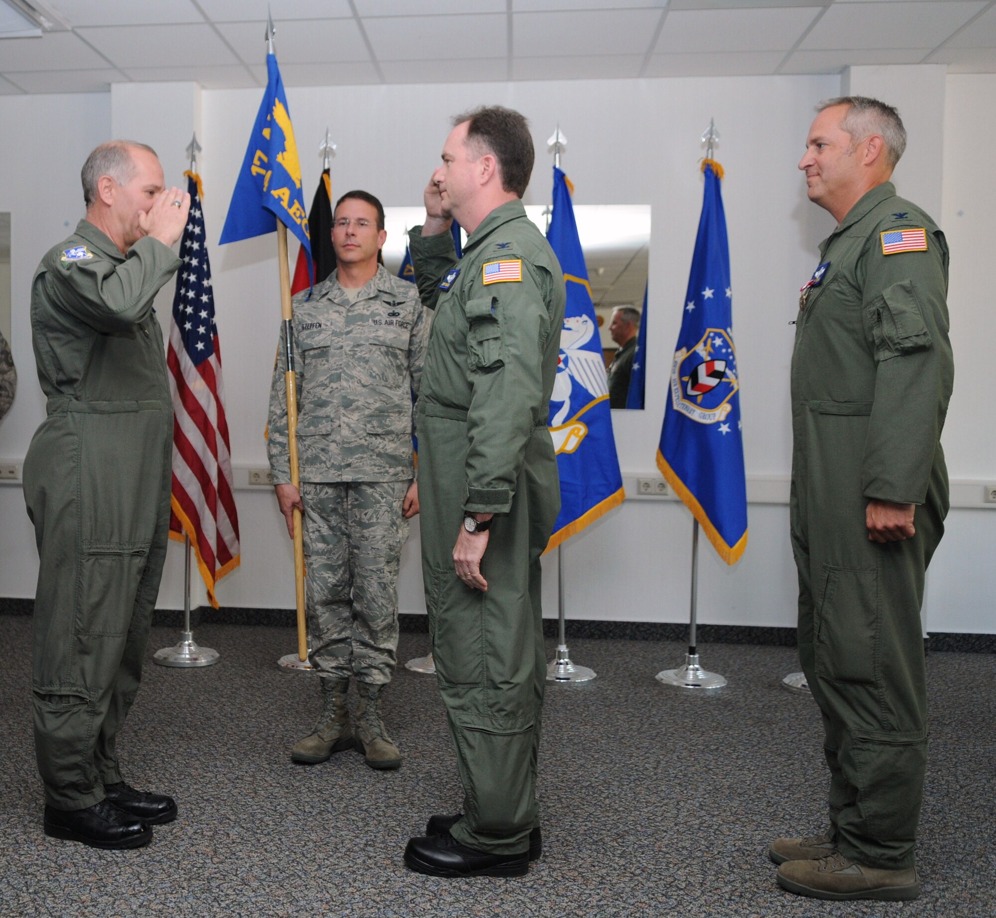 RAMSTEIN AIR BASE, Germany -- Seventeenth Air Force Commander Maj. Gen. Ron Ladnier (left) returns the salute of new 404th Air Expeditionary Group Commander Col. Jeffrey MacDonald (right from center), who took the guidon from Col. Mark Vijums (right) in a change of command ceremony Sept. 11 at Ramstein. Command Chief Master Sgt. Timothy Steffen (left of center) assisted General Ladnier in the transfer of command ceremony. 
Colonel Vijums led the 404th since March and served as the commander of the task force that supported President Obama's visit to Ghana in July. (USAF photo by Master Sgt. Jim Fisher)