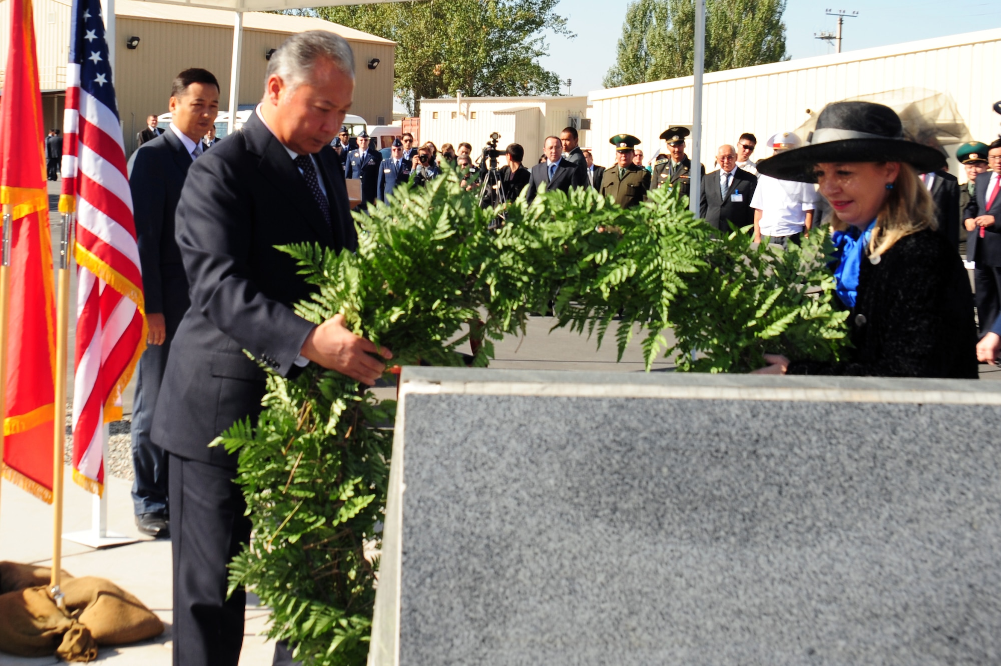Kyrgyz President Kurmanbek Bakiyev and American Ambasador to Kyrgyzstan Tatiana Gfoeller lay a wreath at the Sept. 11 Memorial Sept. 11, 2009, at the Transit Center at Manas, Kyrgyzstan. President Bakiyev honored those who lost their lives in 2001 with a few words of friendship between Kyrgyzstan and the U.S. (U.S. Air Force photo/Senior Airman Steele C. G. Britton) 