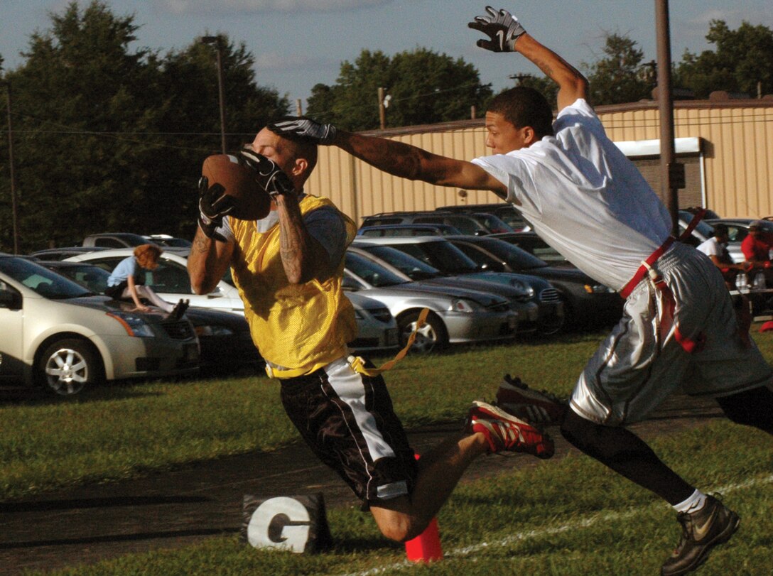 Ronnie Davis, 459th Air Refueling Wing wide receiver, catches a 20-yard touch-down pass over an outstretched Terrell Costa, 316th Force Support Squadron safety, during an opening season game of intramural flag football at the football field outside the Military Personnel Section Sept. 3. The 459 ARW won 18-3 over the 316 FSS. (U.S. Air Force photo/ Bobby Jones)