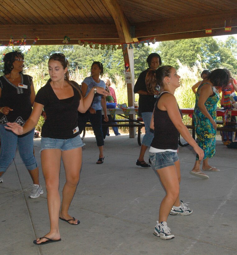 A group of Census Bureau members dance the “Cha Cha Slide” in unison inside the pavilion at Freedom Lake during their annual cookout Sept. 3. The members also enjoyed games of volleyball and horseshoes at the lake. (U.S. Air Force photo/ Bobby Jones)