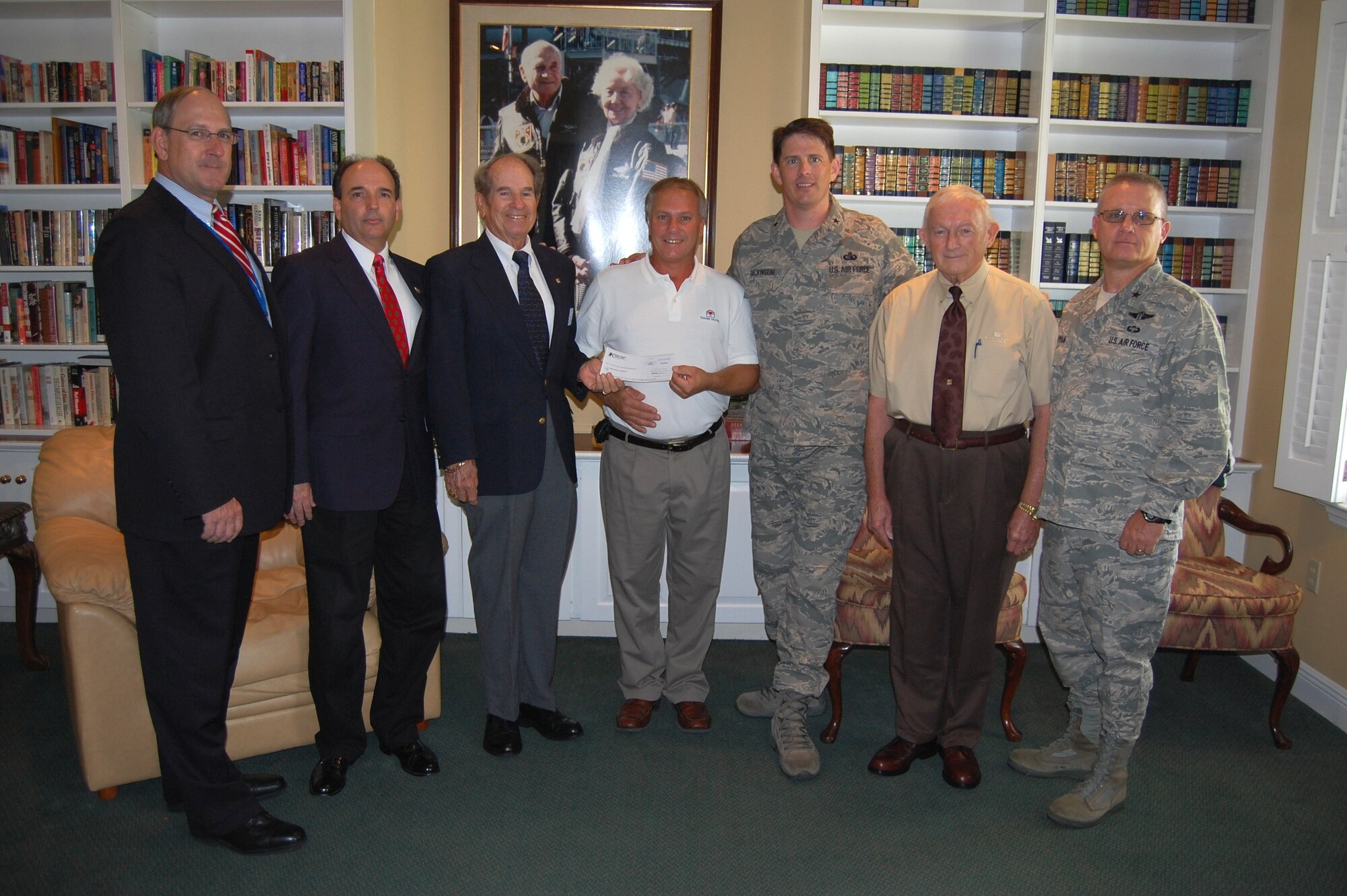 Keesler Fisher House Manager Larry Vetter, center, accepts a $2,000 donation to the local Fisher House from Tommy Adkins, Keesler Federal Credit Union board of directors chairman, Sept. 11 in the facility’s family room.  Also attending are, from left, Thomas Wisnieski, new director of the Gulf Coast Veterans Health Care System; Gary Fulton, manager of the KFCU Larcher branch, Brig. Gen. Ian Dickinson, 81st Training Wing commander, Jerry Caldwell, KFCU board vice chairman, and Brig. Gen. (Dr.) Dan Wyman, 81st Medical Group commander. (U.S. Air Force photo by Steve Pivnick