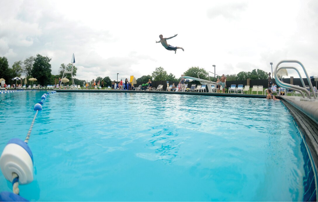 Colton Correll, 15, son of Master Sgt. Aaron Correll, Air National Guard, dives into the base pool during a Labor Day party to mark the end of summer. Despite rain, a large number of patrons showed to celebrate a day filled with food, fun, music and prizes. The pool closed for the summer on Labor Day weekend and is scheduled to reopen Memorial Day weekend 2010.(U.S. Air Force photo/ Senior Airman Steven R. Doty)