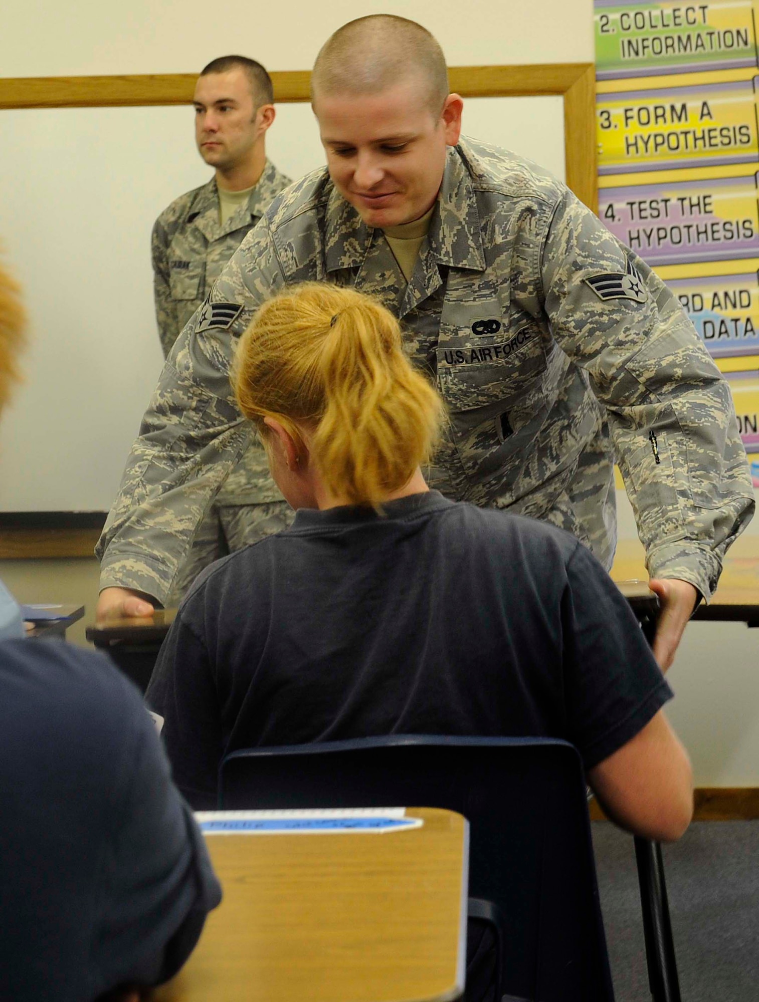 Senior Airman Brain Hepburn, 28th Munitions Squadron munitions systems journeyman, reunites a student with her desk at Spring Creek School near New Underwood, S.D., Sept. 8. Senior Airmen Hepburn, along with other Ellsworth Airmen, volunteered to take the desks out of the classroom prior to student arrival and bring the desks back in the classroom after the students arrived for school to show students the importance of the military and the privilege of education. (U.S. Air Force photo by Airman 1st Class Corey Hook)