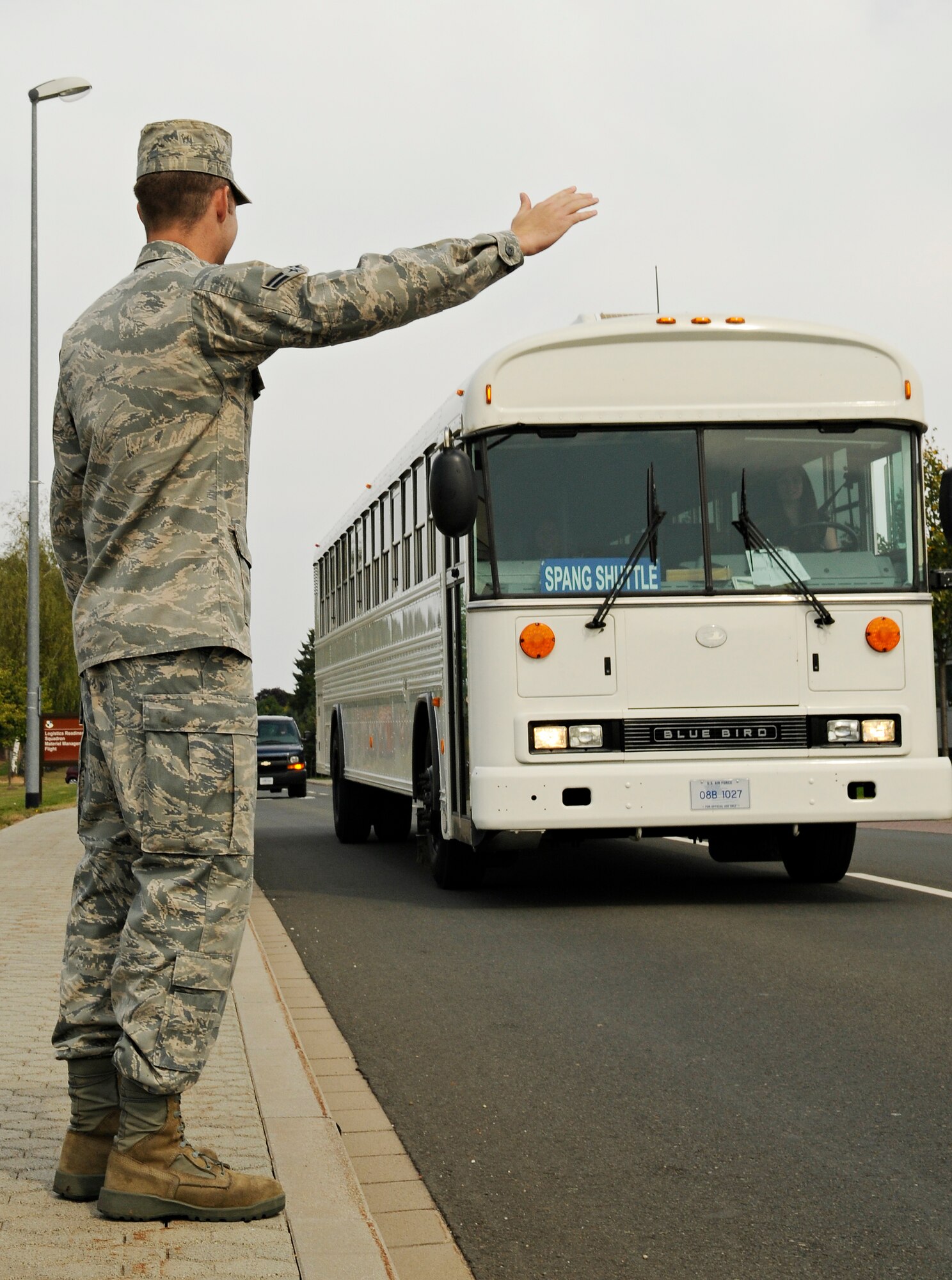 SPANGDAHLEM AIR BASE, Germany – Airman 1st Class Mikala Stokes, 52nd Aircraft Maintenance Squadron, waves down the Spangdahlem Shuttle between bus stops Sept. 9. The Spangdahlem shuttle will stop for any base member anywhere along its route if the person signals for a ride. (U.S. Air Force photo/Senior Airman Benjamin Wilson)