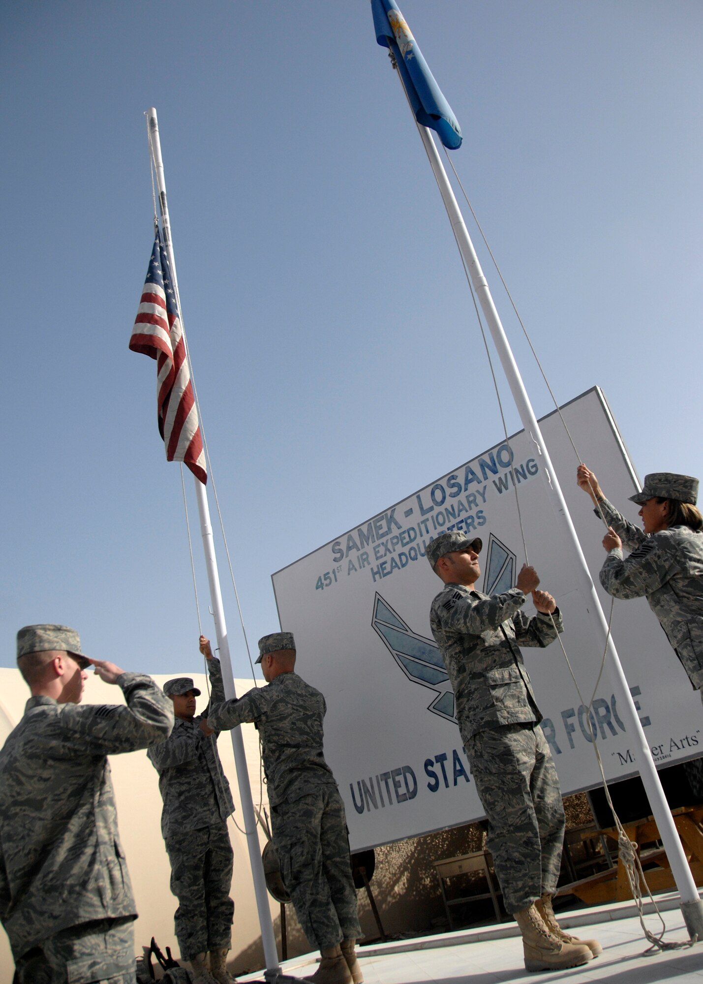 The 451st Honor Guard lowers the American flag to half staff to commemorate those who lost their lives to the Sept. 11 attacks here on Sept. 11, 2009. On Sept. 11, 2001, four planes were hijacked; one fell short of it's destination but three killed approximately 3,000 people. We will never forget the events that took place or the people who fell on the day. (U.S. Air Force photo/Senior Airman Timothy Taylor)