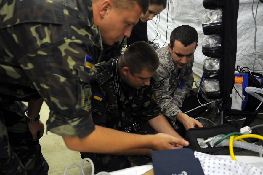 Staff Sgt. Kelly Kramer, 458th Expeditionary Medical Squadron, describes the workings of medical equipment to multi-national troops during an exercise orientation Tuesday, Sept. 8, 2009, in Nis, Serbia. The 458th EMEDS stood up in support of the 2009 Military Medical Training Exercise in Central and Eastern Europe Sept. 2 – 13. The exercise, hosted by Serbia, provides a joint medical learning environment and assisting host nation civilian and military services; international, private and volunteer organizations; and other participating nations in enhancing disaster response actions. Fifteen nations participated in the exercise. (U.S. Air Force Photo/Senior Airman Alex Martinez)