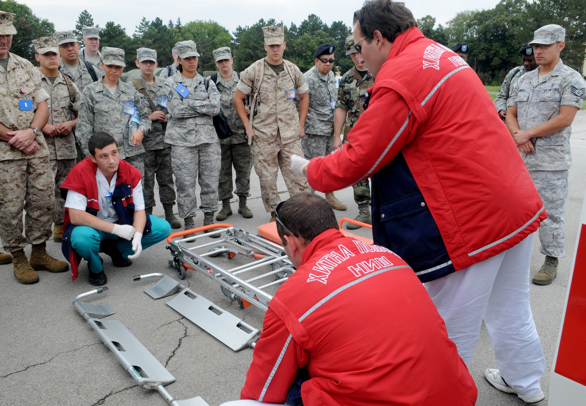 Serbian Red Cross members explain medical evacuation procedures to U.S. troops during an exercise orientation Tuesday, Sept. 8, 2009, in Nis, Serbia. The Serbian Red Cross worked alongside a U.S. mobile hospital housing the 458th Expeditionary Medical Squadron. The 458th EMEDS stood up in support of the 2009 Military Medical Training Exercise in Central and Eastern Europe Sept. 2 – 13. The exercise, hosted by Serbia, provides a joint medical learning environment and assists host nation civilian and military services; international, private and volunteer organizations; and other participating nations in enhancing disaster response actions. Fifteen nations participated in the exercise. (U.S. Air Force Photo/Senior Airman Alex Martinez)