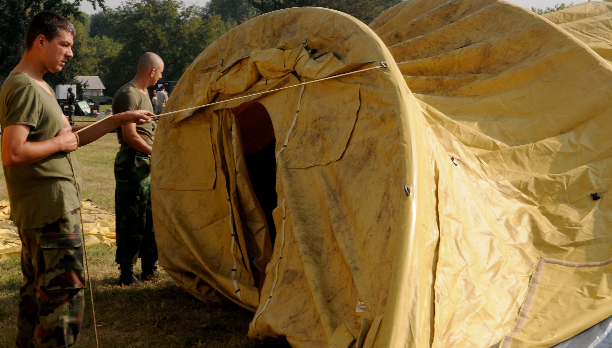 Serbian soldiers set up tents for a mobile hospital Tuesday, Sept. 1, 2009, in Nis, Serbia. Serbian medical practitioners erected tents alongside the 458th Expeditionary Medical Squadron as a joint effort for the 2009 Military Medical Training Exercise in Central and Eastern Europe Sept. 2 – 13. The exercise, hosted by Serbia, provides a joint medical learning environment and assists host nation civilian and military services; international, private and volunteer organizations; and other participating nations in enhancing disaster response actions. Fifteen nations participated in the exercise. (U.S. Air Force Photo/Senior Airman Alex Martinez)