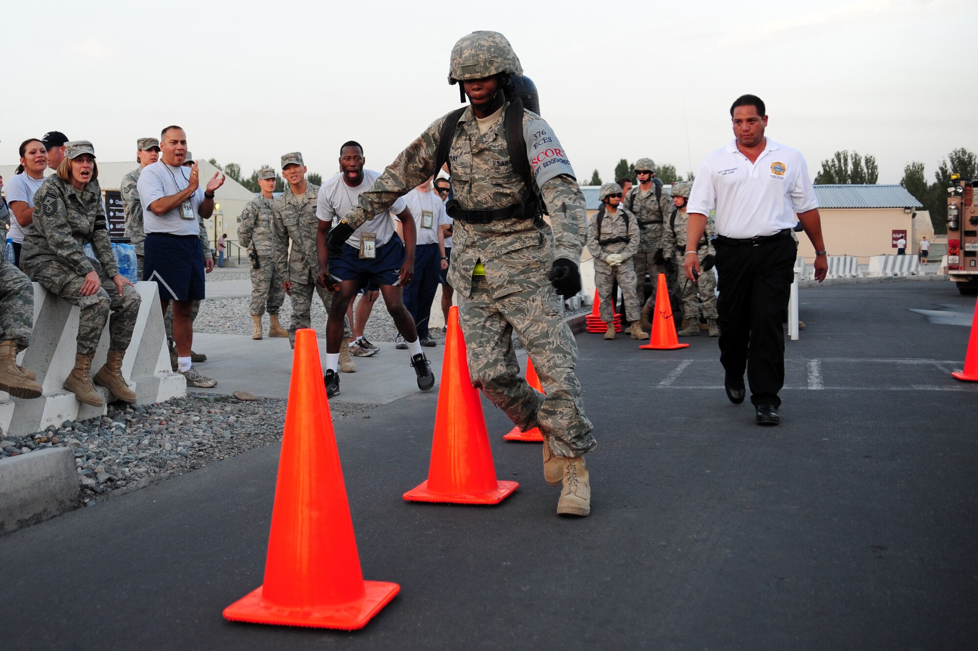 TRANSIT CENTER AT MANAS, Kyrgyzstan -- Senior Airman Devin Ray, 376th Expeditionary Civil Engineer Squadron security escort, weaves between cones as part of the Fire Fighter Challenge at the Transit Center. Manas fire fighters challenged airmen to practice their skills at training tactics used in real-world fire training. (U.S. Air Force photo/Senior Airman Steele C. G. Britton)
