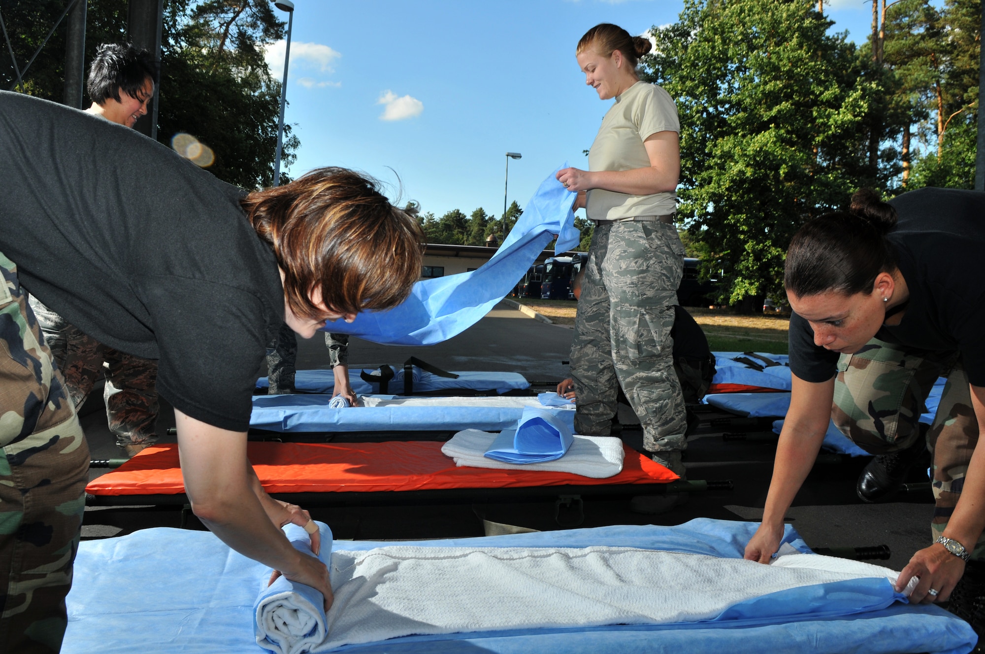 (From left to right starting in the front) U.S. Air Force Tech. Sgt. Christina Werkin, Tech. Sgt. Laura Small, Staff Sgt. Frances Sturdevant, and Senior Airman Lisa Kennedy, 86th Contingency Aeromedical Staging Facility medical technicians, prepare gurneys, Ramstein Air Base, Germany, Aug. 27, 2009. The gurneys will be used to transport wounded warriors to an aircraft taking them to Walter Reed Army Medical Center for further medical treatment. (U.S. Air Force photo by Senior Airman Nathan Lipscomb)