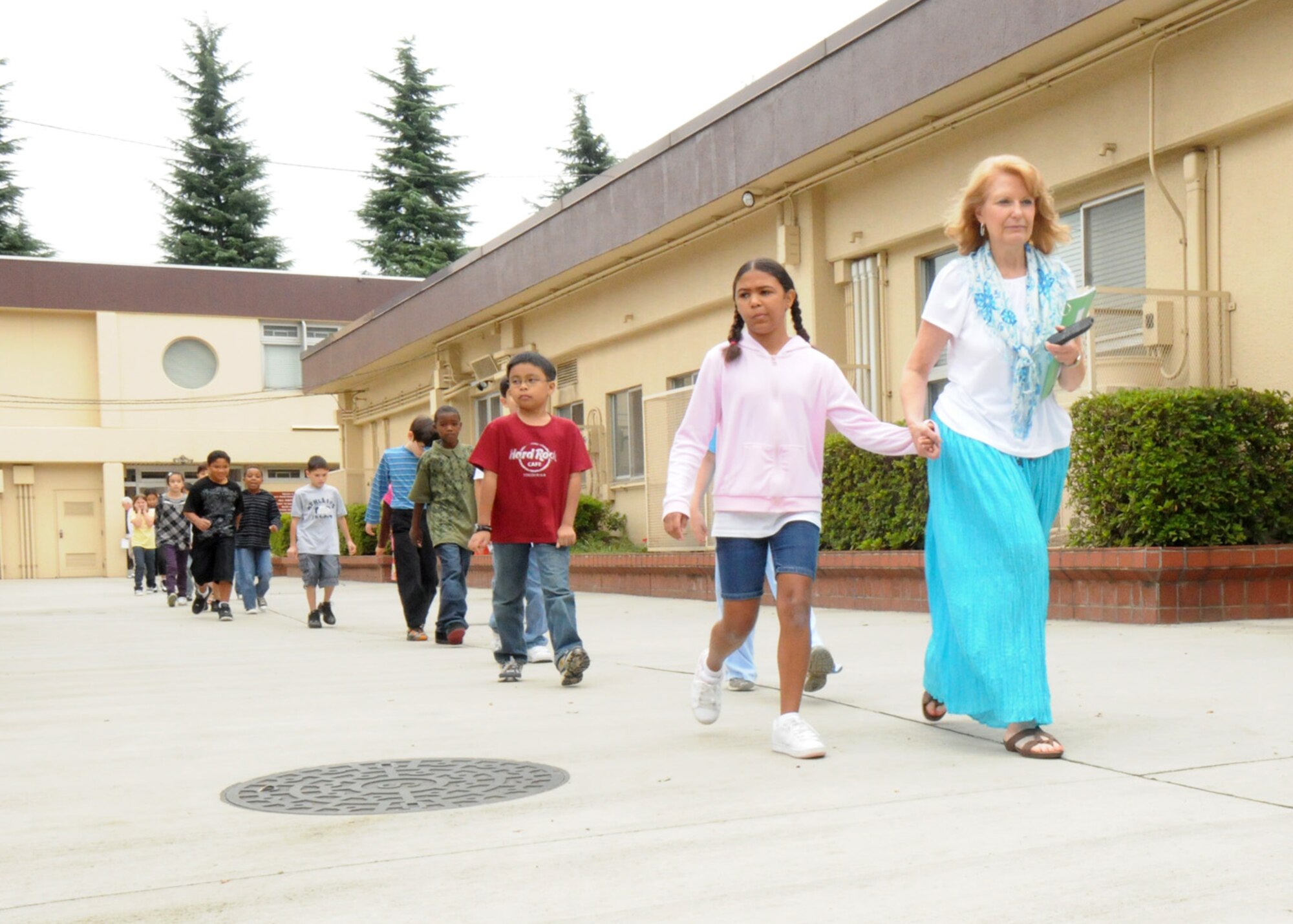 YOKOTA AIR BASE, Japan -- A teacher leads her students at Joan K. Mendel Elementary School from the building during a scheduled fire drill. Fire prevention week is set for Oct.13-17. During fire prevention week the Yokota Fire Department will sponsor activities for children across the base to educate children and their parents on fire prevention and detection. (U.S. Air Force photo/Staff Sgt. Veronica Pierce)