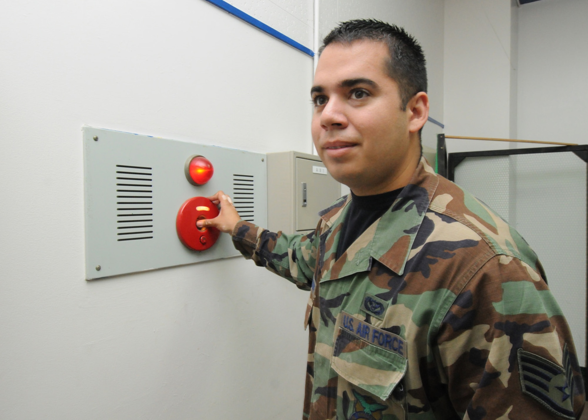 YOKOTA AIR BASE, Japan -- Staff Sgt. Reuben Hermsdorf, 374th Civil Engineer Squadron fire department, presses a fire alarm at Joan K. Mendel Elementary School during a scheduled fire drill. Fire prevention week is set for Oct. 13-17. During fire prevention week the Yokota Fire Department will sponsor activities for children across the base to educate children and their parents on fire prevention and detection. (U.S. Air Force photo/Staff Sgt. Veronica Pierce) 