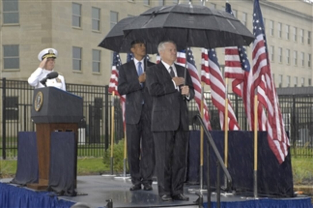 Honoring those who died in the Sept. 11, 2001, terrorist attack on the Pentagon, President Barack Obama (2nd from right) joined Secretary of Defense Robert M. Gates (right) and Chairman of the Joint Chiefs of Staff Adm. Mike Mullen (left), U.S. Navy, for a wreath laying ceremony at the Pentagon Memorial on Sept. 11, 2009.  At the beginning of the ceremony, everyone stood for the playing of the national anthem.  