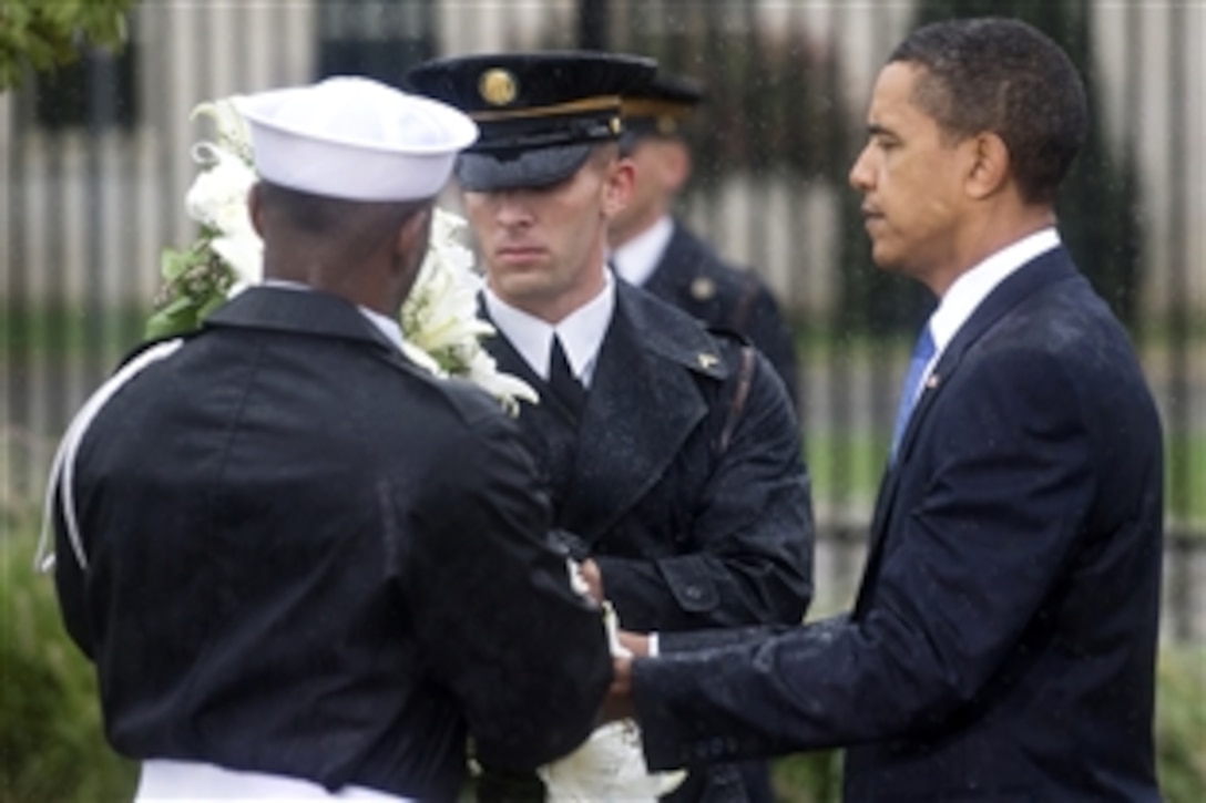 President Barack Obama lays a wreath at the 9/11 commemoration ceremony at the Pentagon, Sept. 11, 2009. It marks the eighth anniversary of the terrorist attacks that killed 59 passengers onboard hijacked American Airlines flight 77, which crashed into the Pentagon to kill 125 inside.