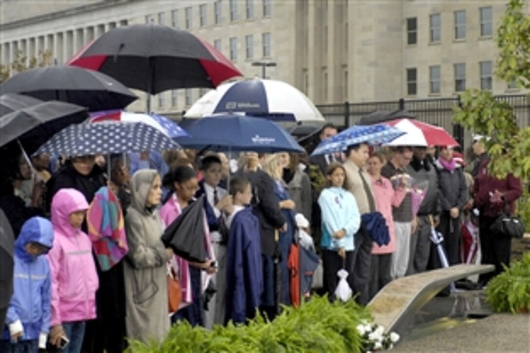 Families who suffered the loss of a relative in the Sept. 11, 2001, terrorist attacks on the Pentagon gather under rainy skies to participate in a memorial ceremony at the Pentagon Memorial, Sept. 11, 2009.