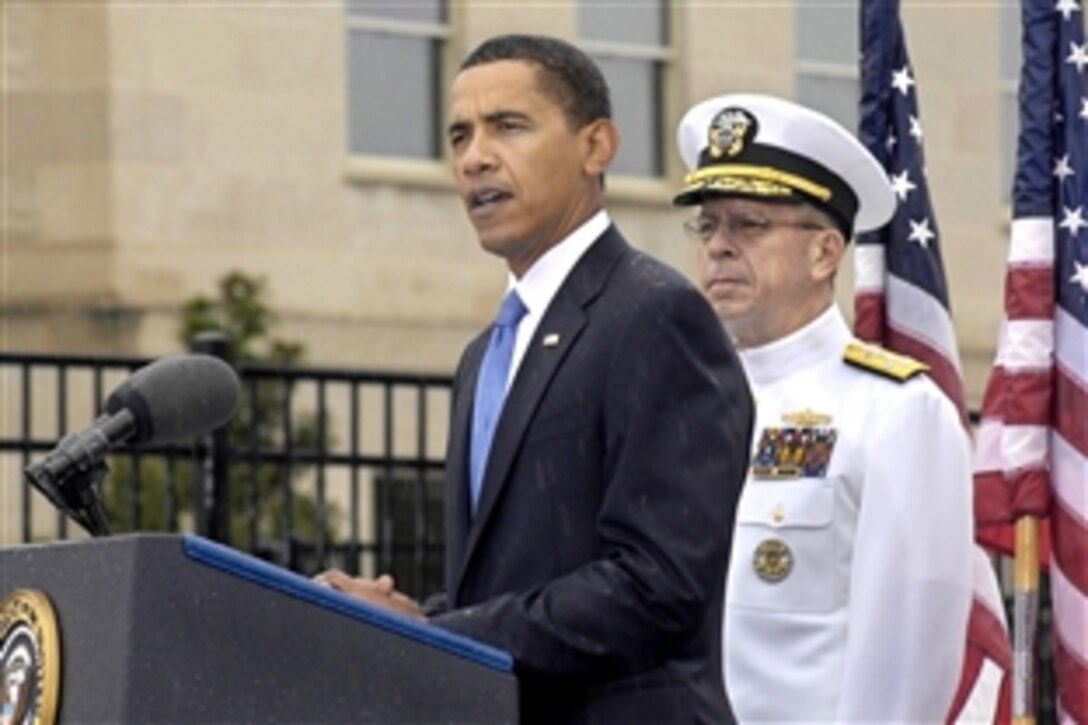 President Barack Obama addresses the audience gathered to mark the eighth anniversary of the 9/11 terrorist attacks at a remembrance ceremony at the Pentagon Memorial, Sept. 11, 2009. Navy Adm. Mike Mullen, chairman of the Joint Chiefs of Staff, right, also offered remarks.