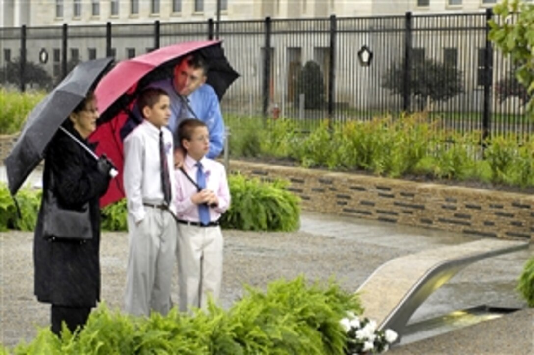 Regan Howell and his two sons, Ashton, 8, and Alex, 12, arrive early for the 9/11 remembrance ceremony at the Pentagon Memorial, Sept. 11, 2009.  Howell's brother, who worked for the Navy at the Pentagon, was among the 125 Pentagon employees killed in the attack.