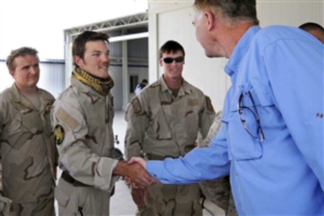 U.S. Deputy Defense Secretary William J. Lynn III greets U.S. Air Force pararescue jumpers while touring a Role 3 hospital in Bastion, Afghanistan, Sept. 10, 2009. 