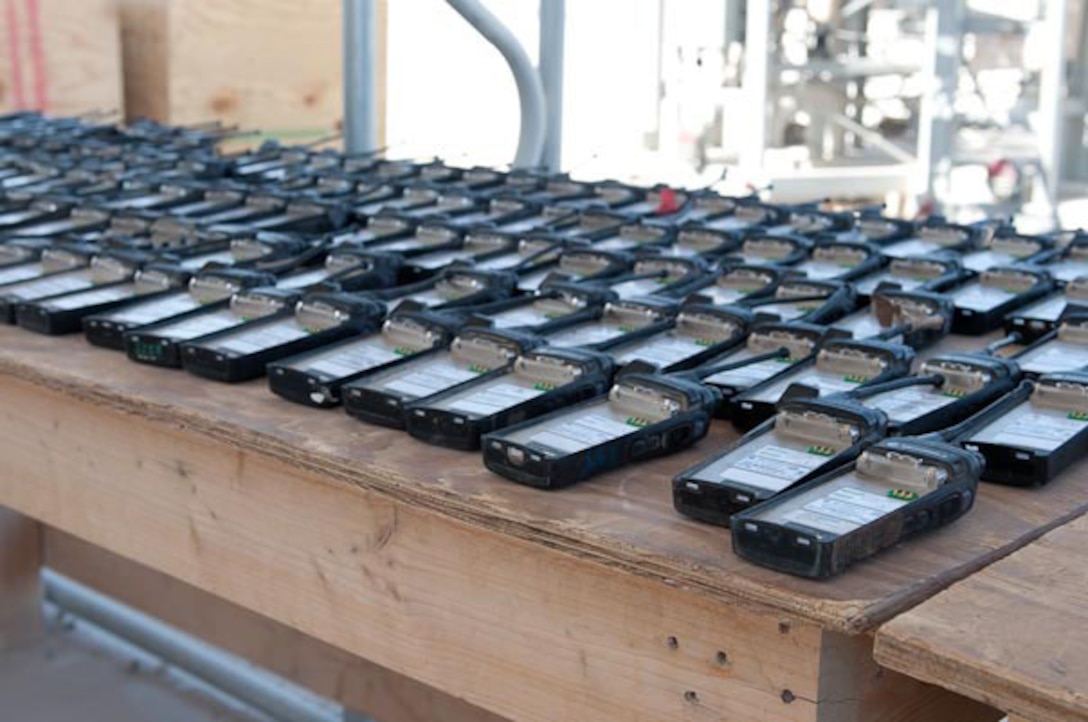 Rows of radios are lined up waiting to be inventoried by Marines from Electronics Maintenance Company, Maintenance Battalion, CLR-27 (Fwd). Five Marines deployed to Iraq to facilitate the responisbile drawdown . (Official Marine Corps photo by Marine Staff Sgt. Helen M. Searcy).